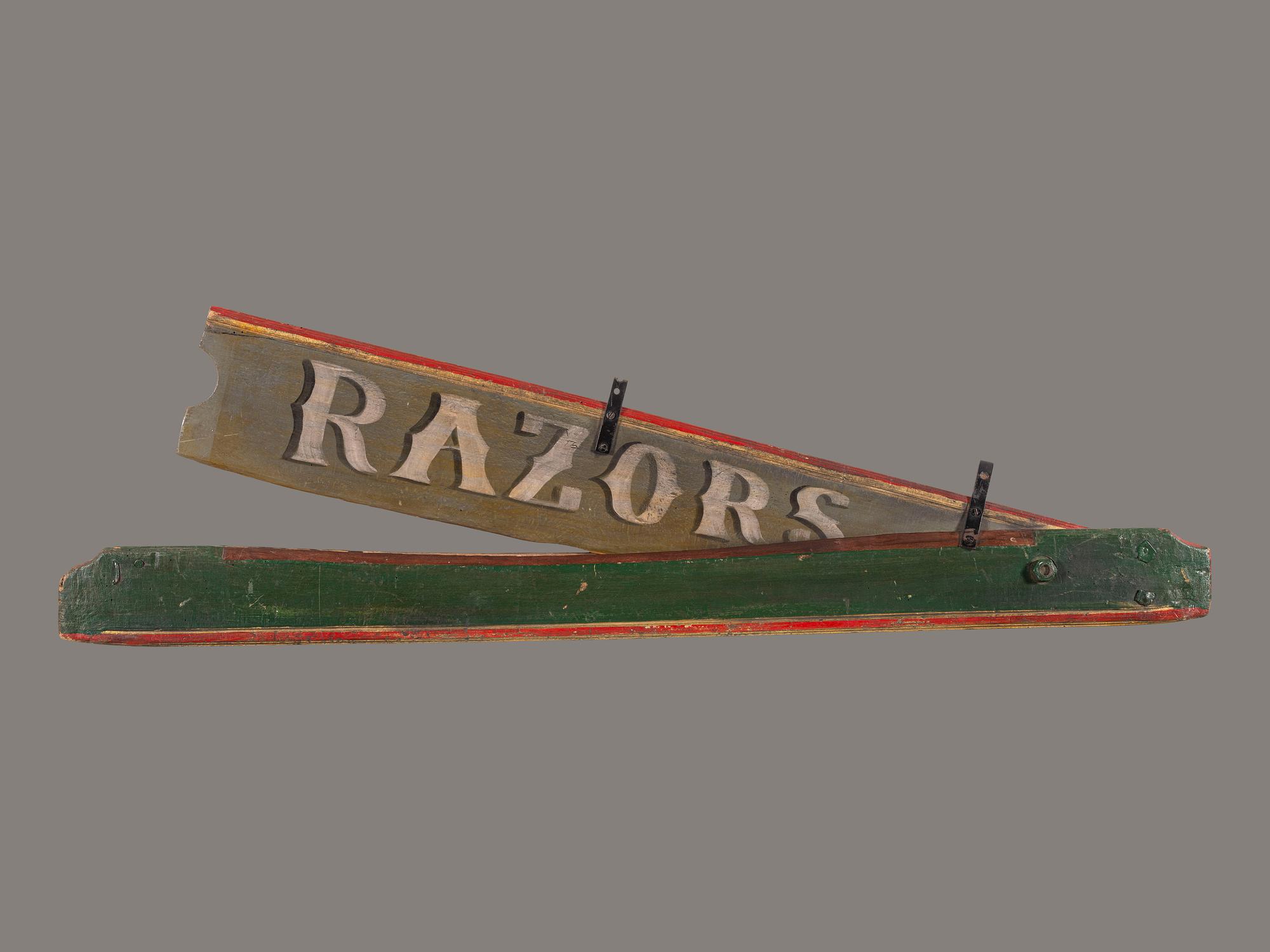 A Polychrome Painted Pine Razor Barber Shop Sign