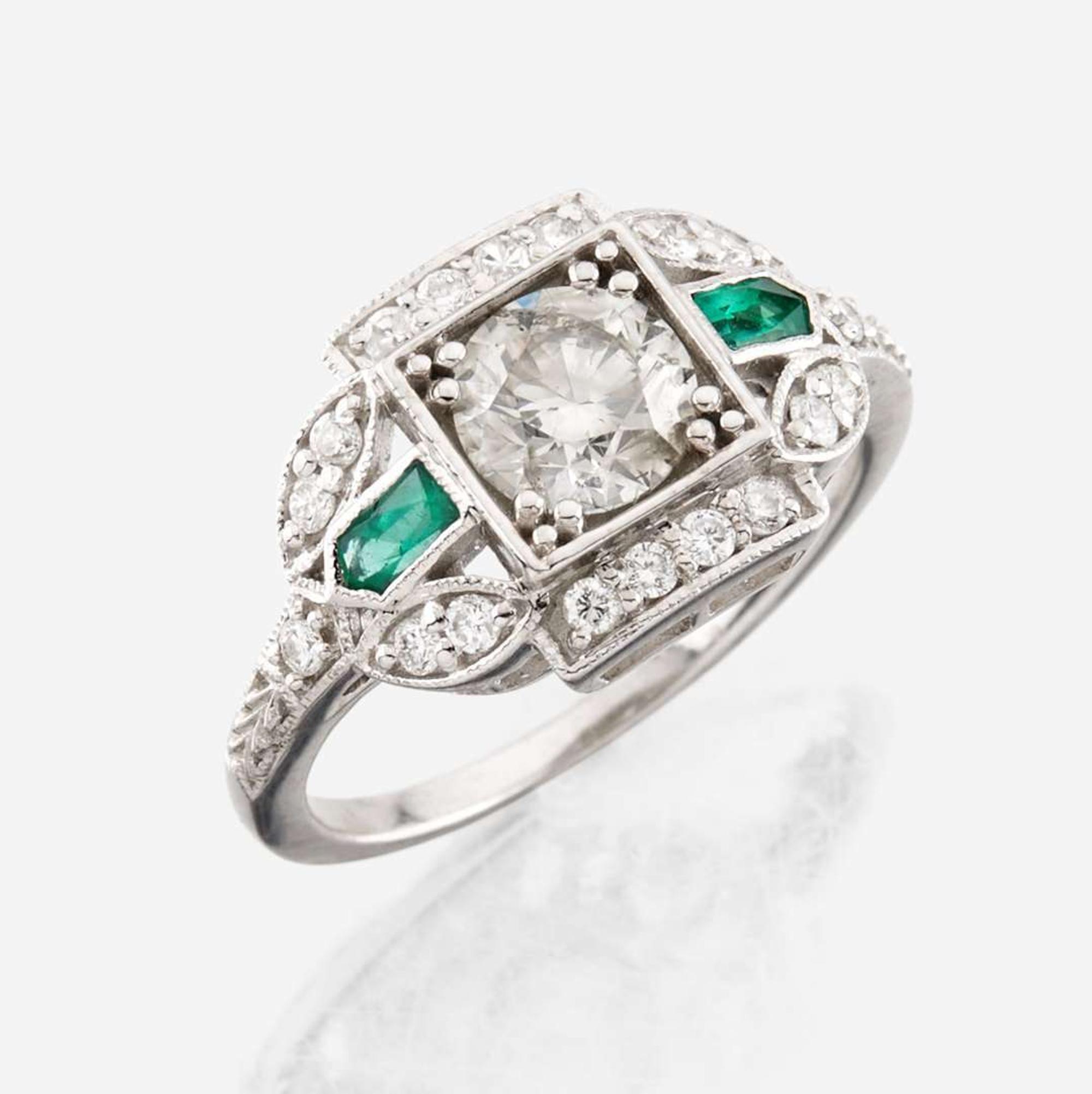 A diamond, emerald, and white gold ring