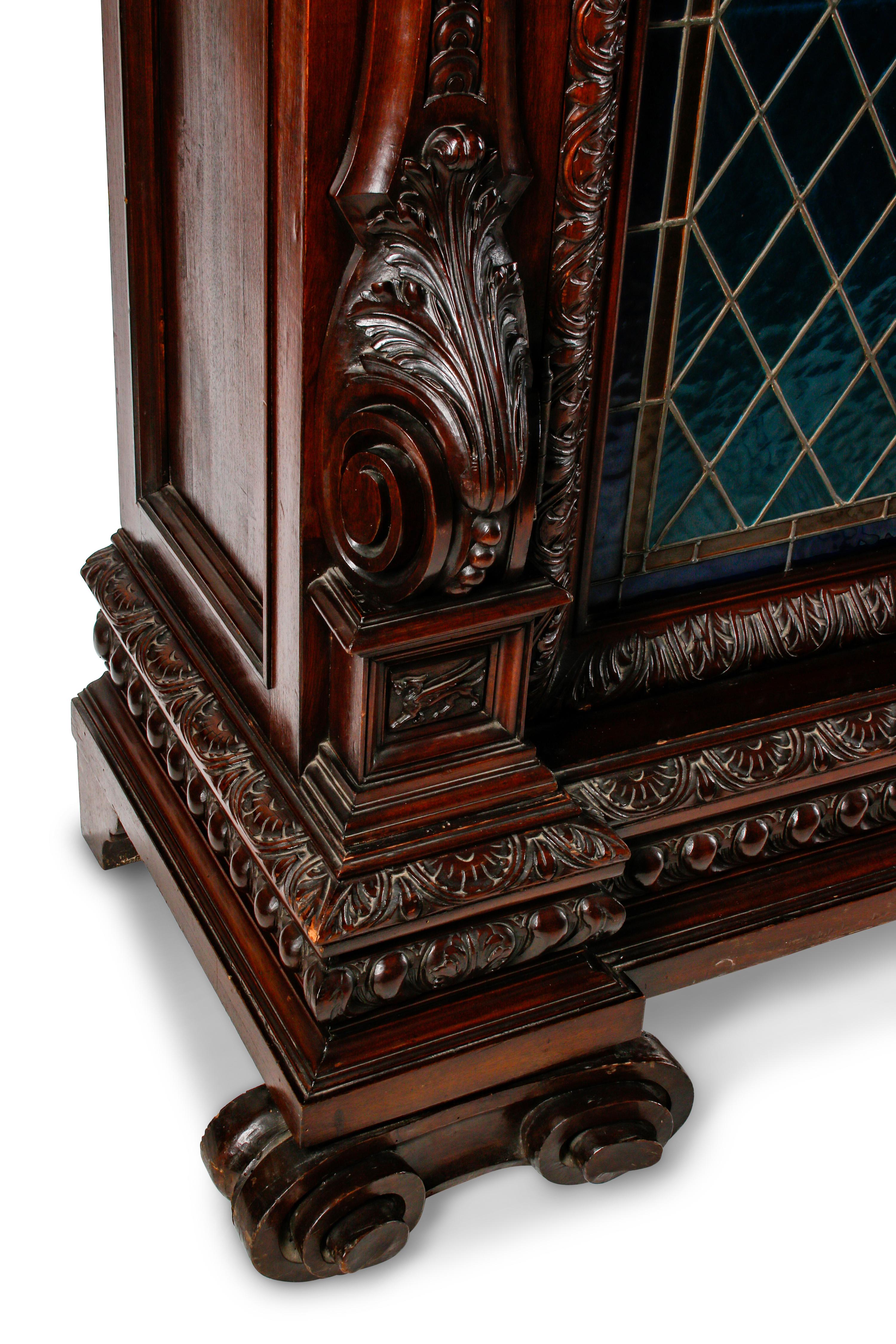 A Continental Renaissance Revival Carved Walnut and Leaded Glass Cabinet