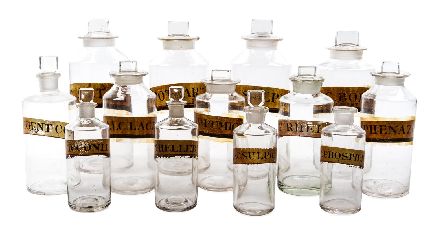 A Group of Thirteen Blown Glass Apothecary Bottles Height of tallest 10 inches.