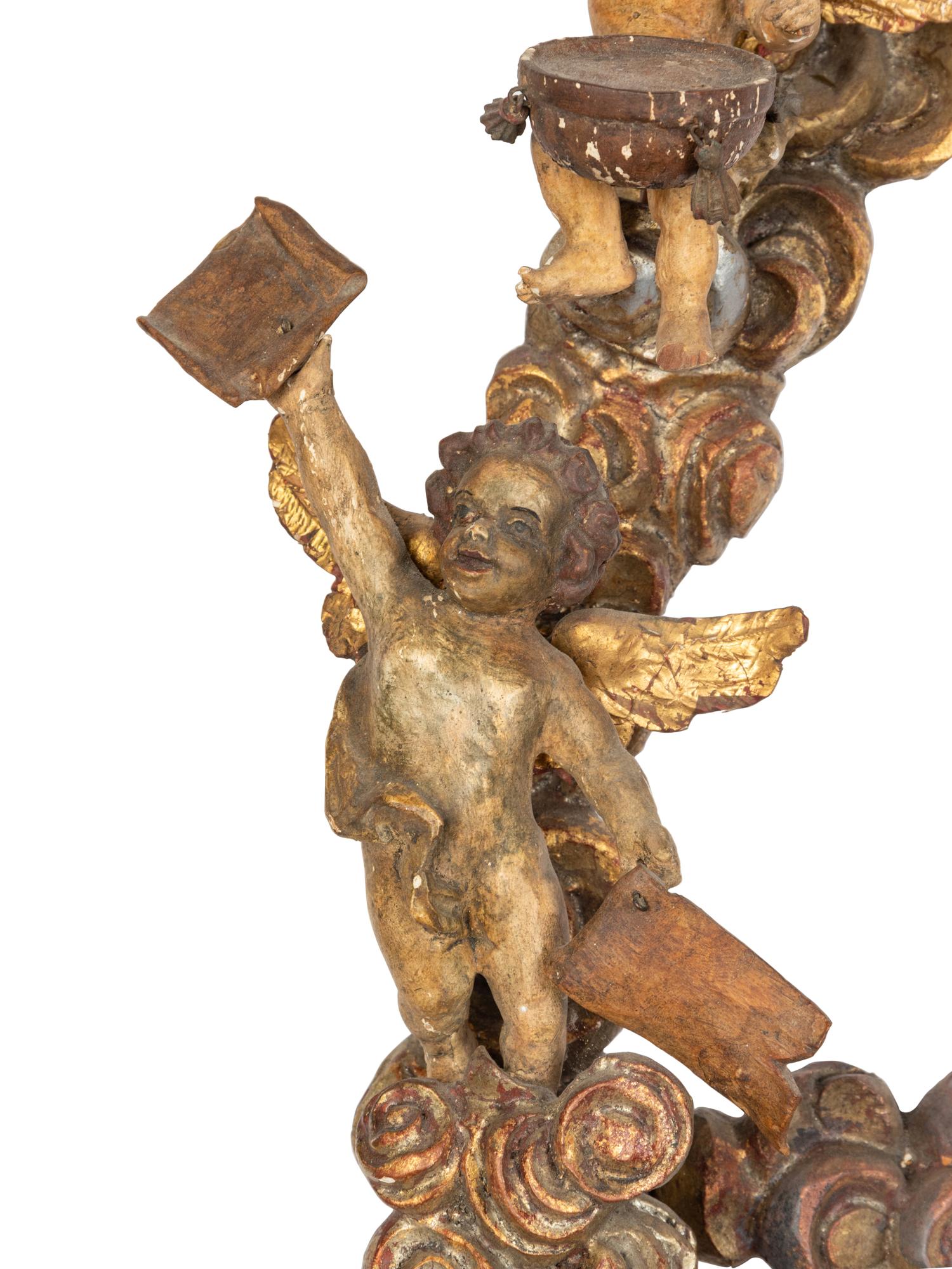 A Florentine Carved Giltwood and Silvered Wood Altarpiece with Musical Putti