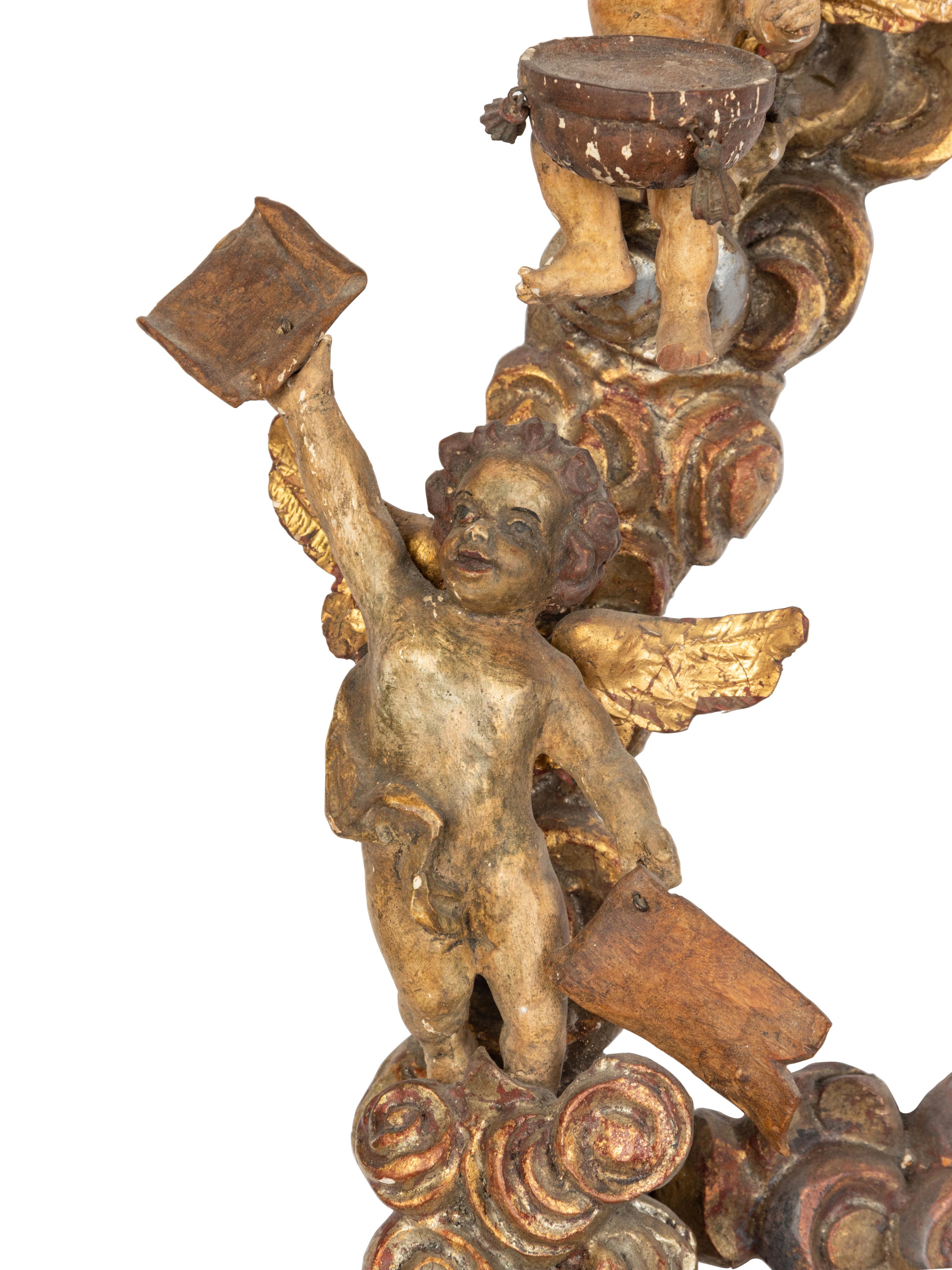 A Florentine Carved Giltwood and Silvered Wood Altarpiece with Musical Putti