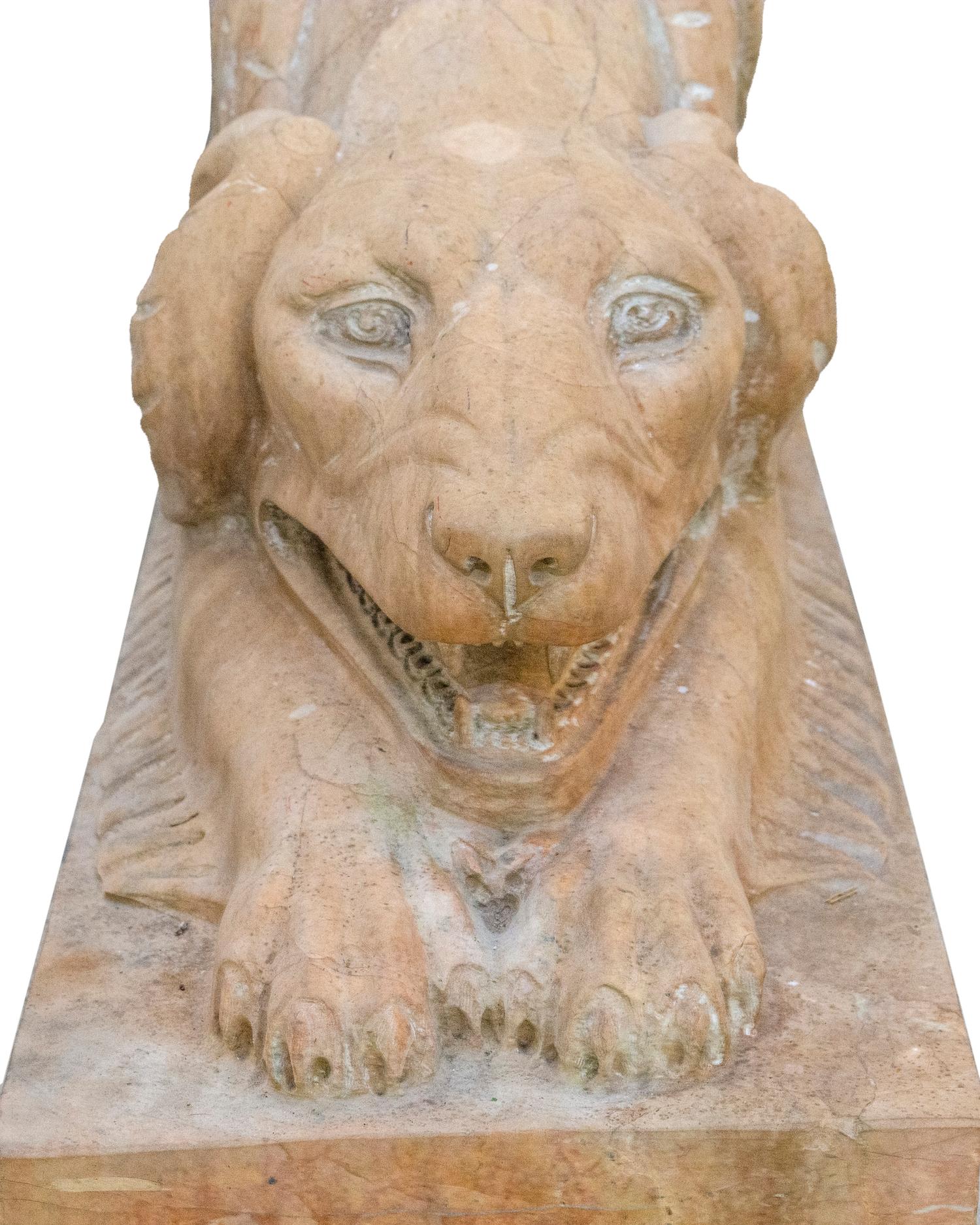 A Pair of Carved Marble Crouching Dogs — 20TH CENTURY