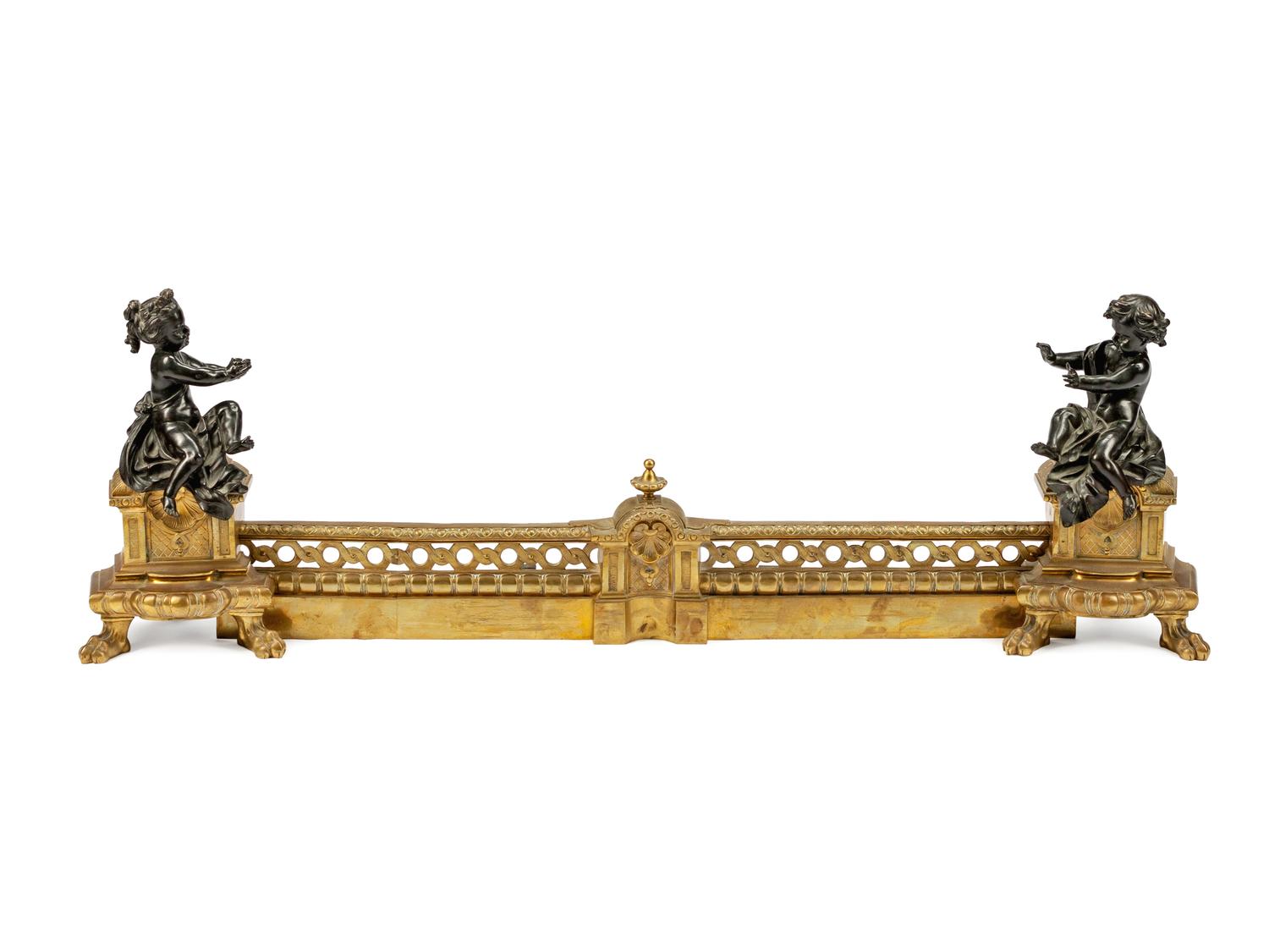 A Pair of Louis XVI Style Parcel-Gilt and Patinated Bronze Chenets and Fender