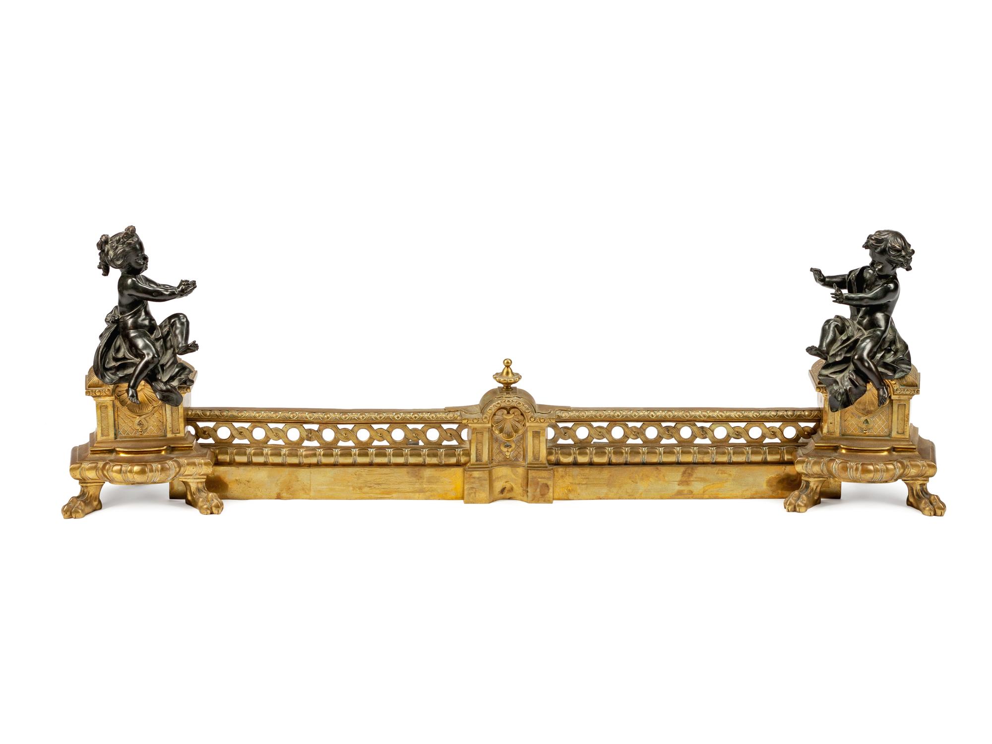 A Pair of Louis XVI Style Parcel-Gilt and Patinated Bronze Chenets and Fender