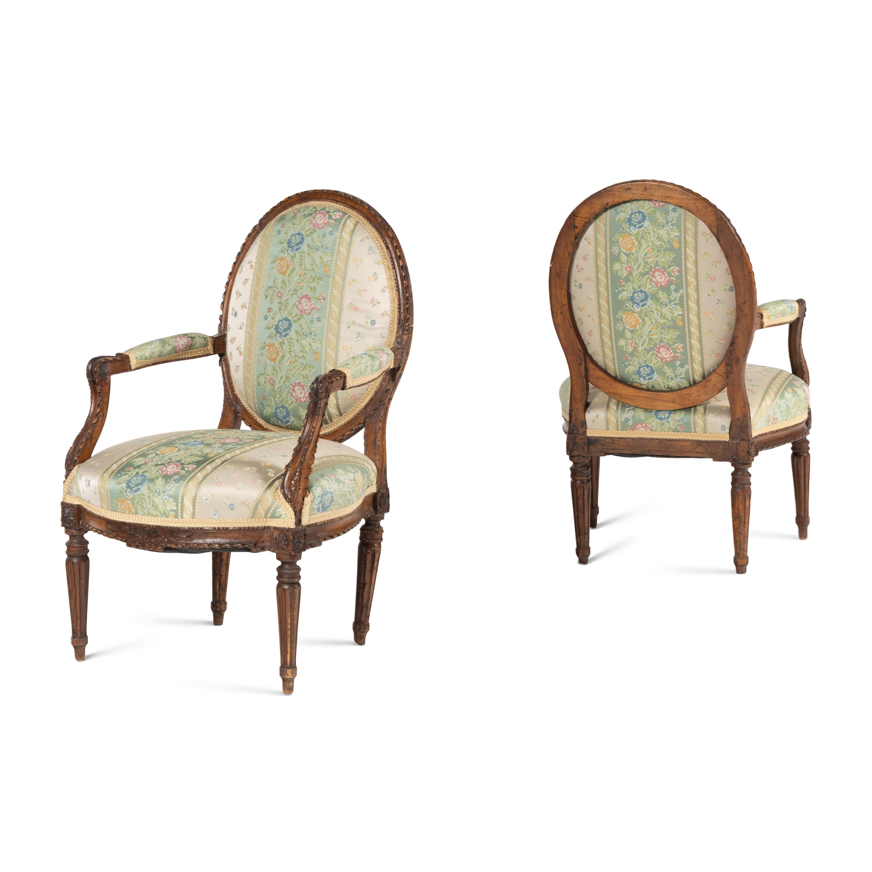 A Pair of Louis XVI Carved Walnut Fauteuils