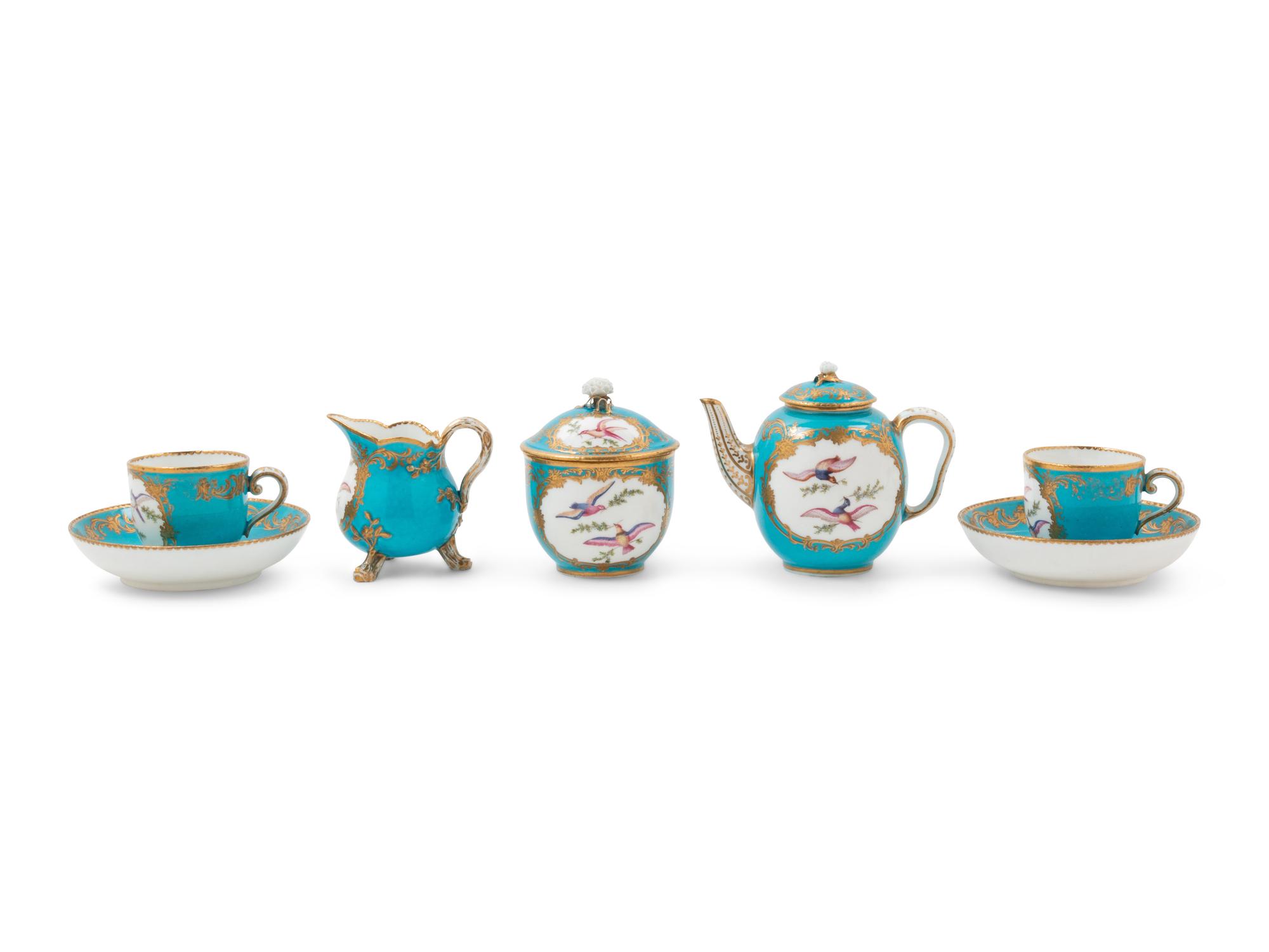 A Sèvres Painted and Parcel Gilt Porcelain Tea and Cordial Service in a Fitted Kingwood and Parquetry Traveling Case