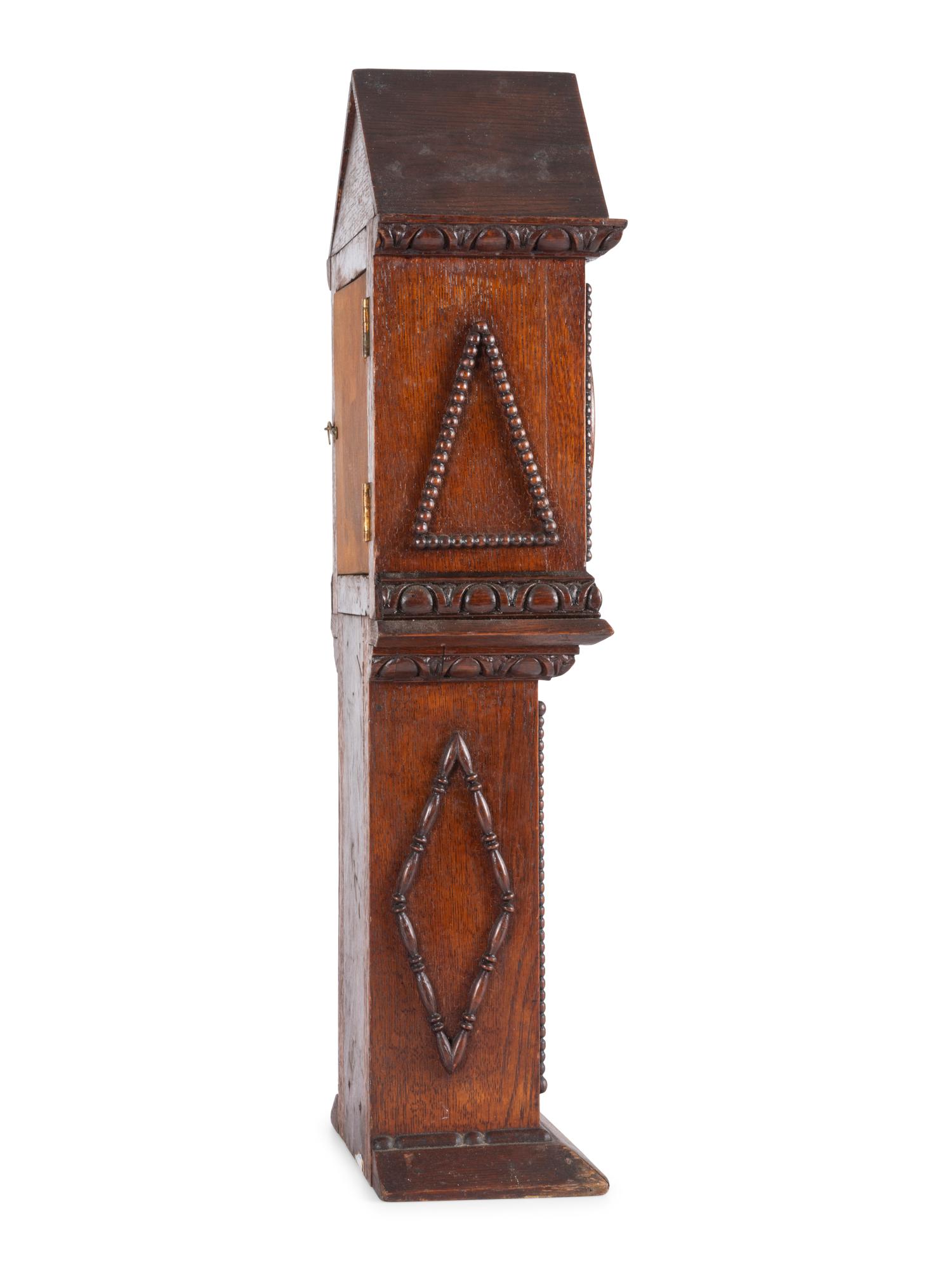 A Miniature Carved Tall Case Clock