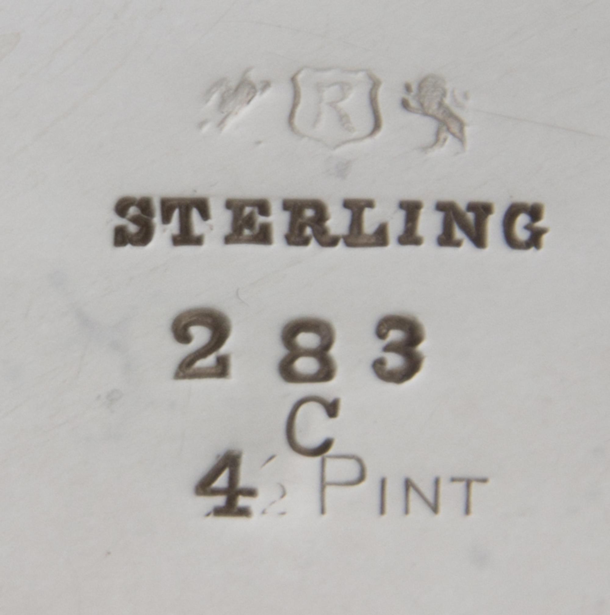 An American Silver Water Pitcher, Reed & Barton, Taunton, MA, the body of square tapering form, worked to show floral sprays and foliat