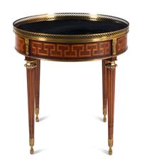 A Louis XVI Style Gilt Metal Mounted Marble-Top Mahogany Guéridon