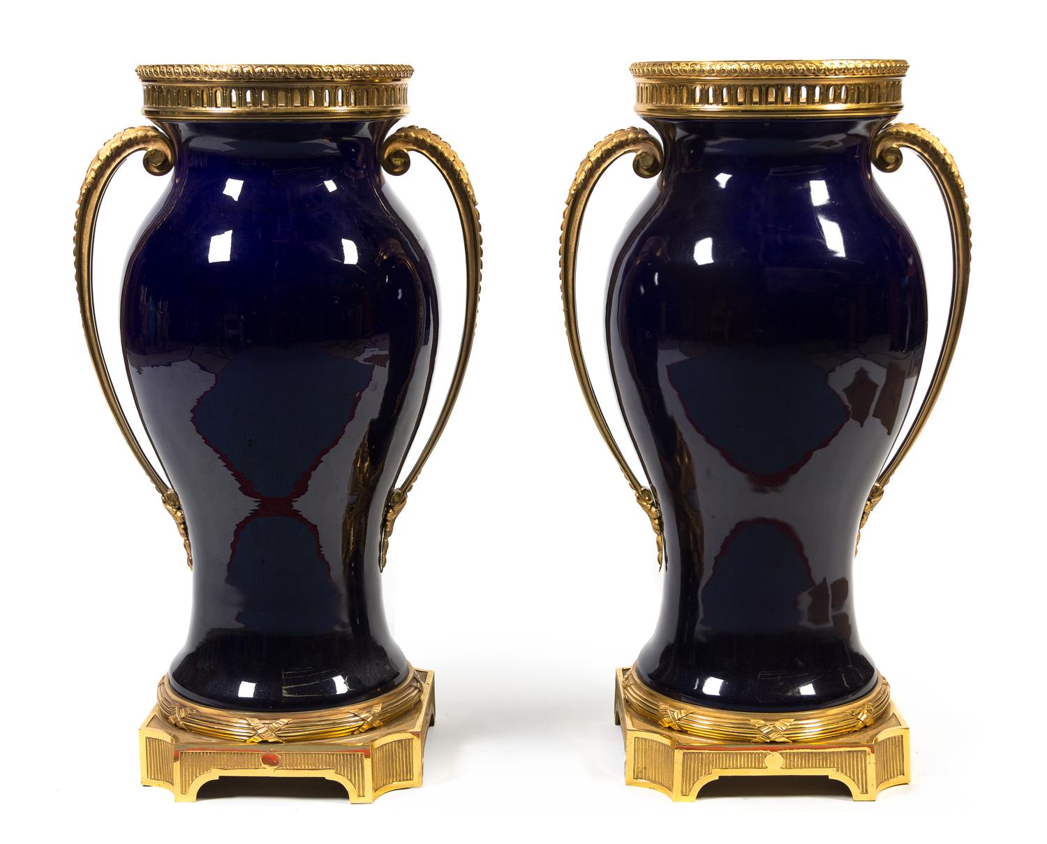 A Pair of French Gilt Bronze Mounted Cobalt Glazed Ceramic Urns Height 33 inches. — 20TH CENTURY