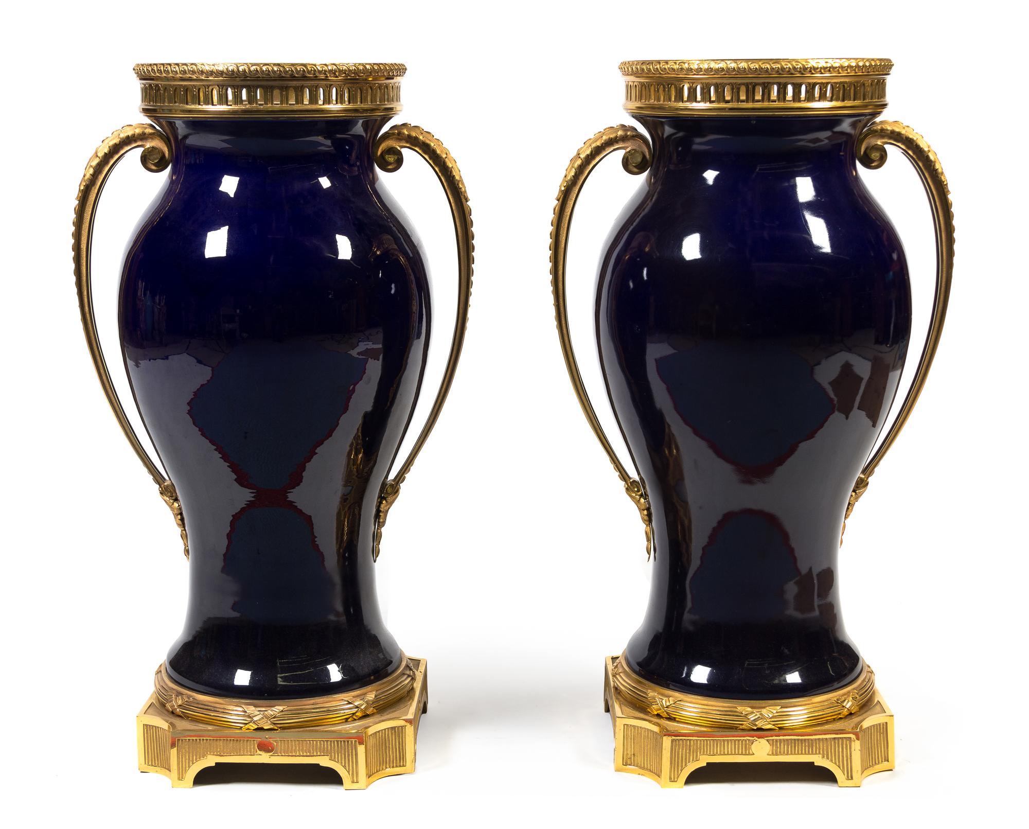 A Pair of French Gilt Bronze Mounted Cobalt Glazed Ceramic Urns Height 33 inches. — 20TH CENTURY