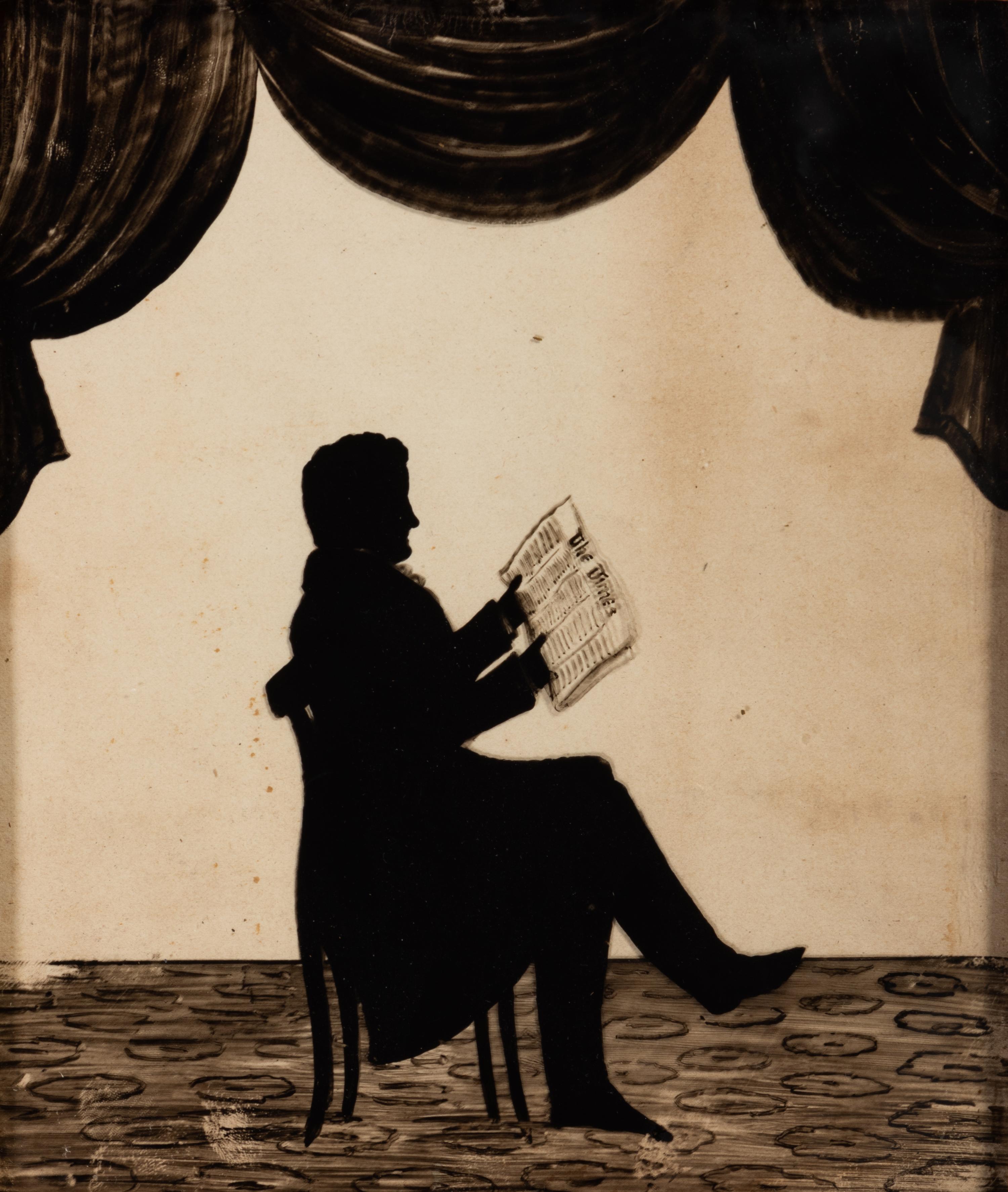 A Reverse Glass Painted Silhouette of a Gentleman Reading
