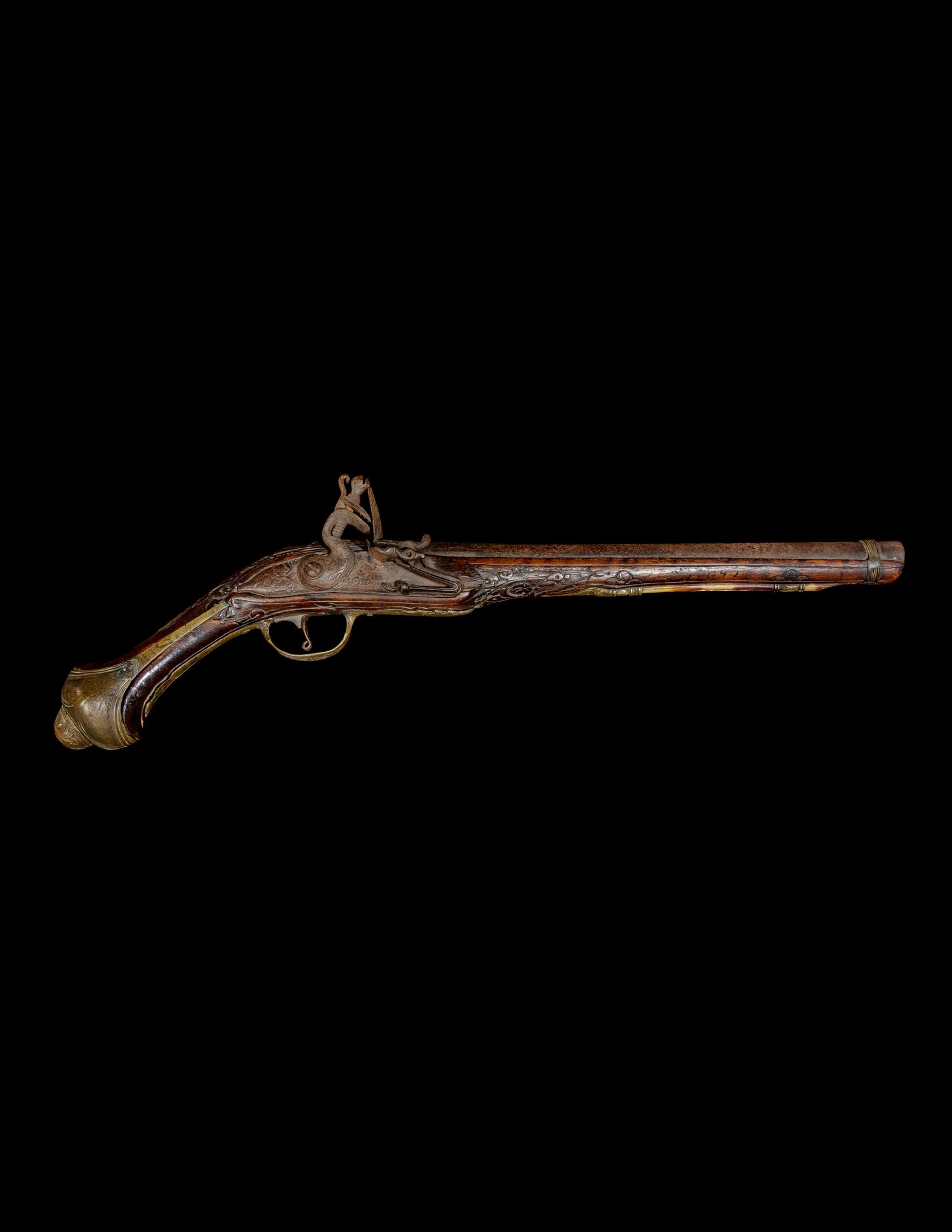 An Engraved Brass-Mounted Flintlock Pistol