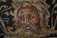 A Roman-Style Polychrome Mosaic Panel with a Bearded Head and Two Animals