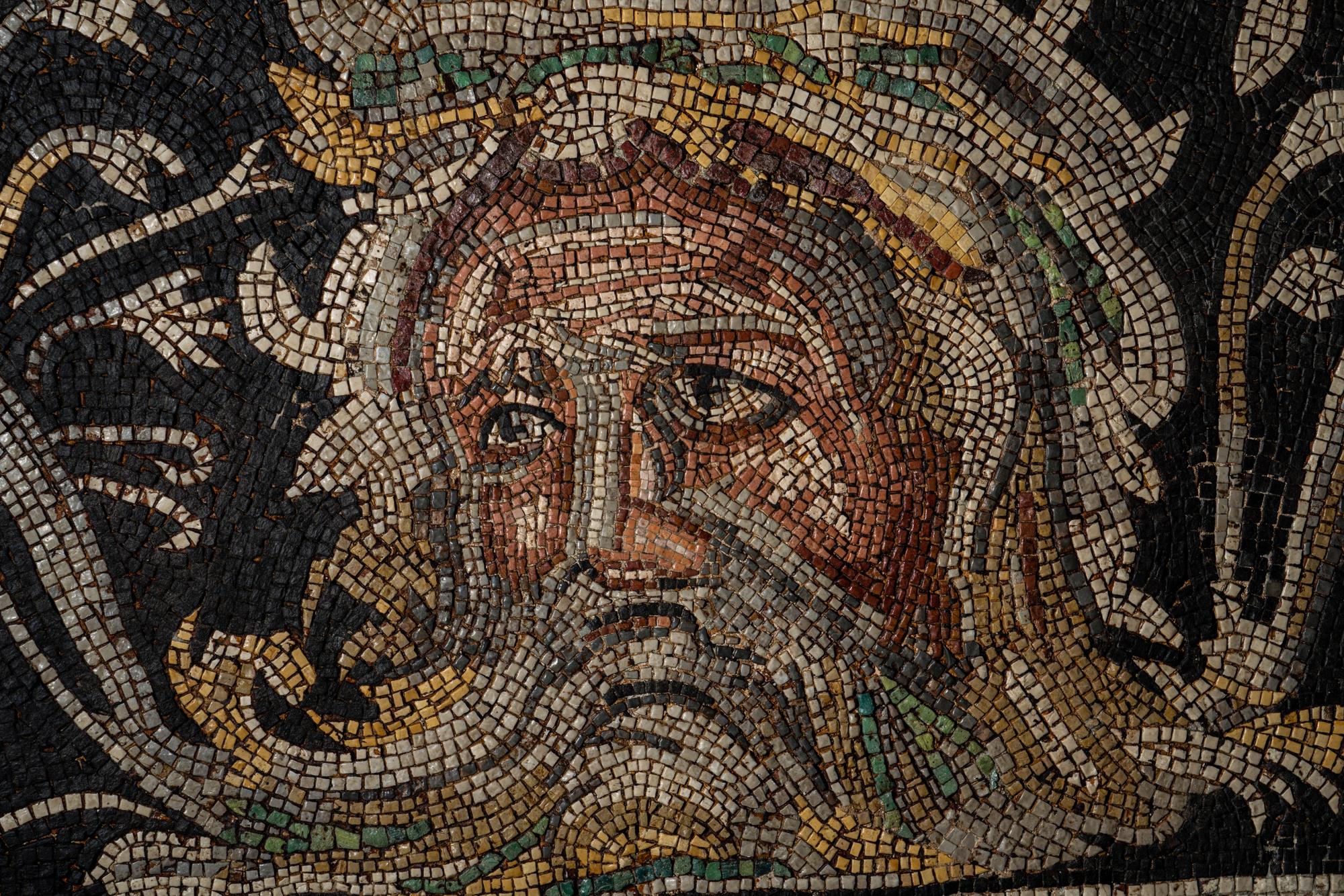 A Roman-Style Polychrome Mosaic Panel with a Bearded Head and Two Animals