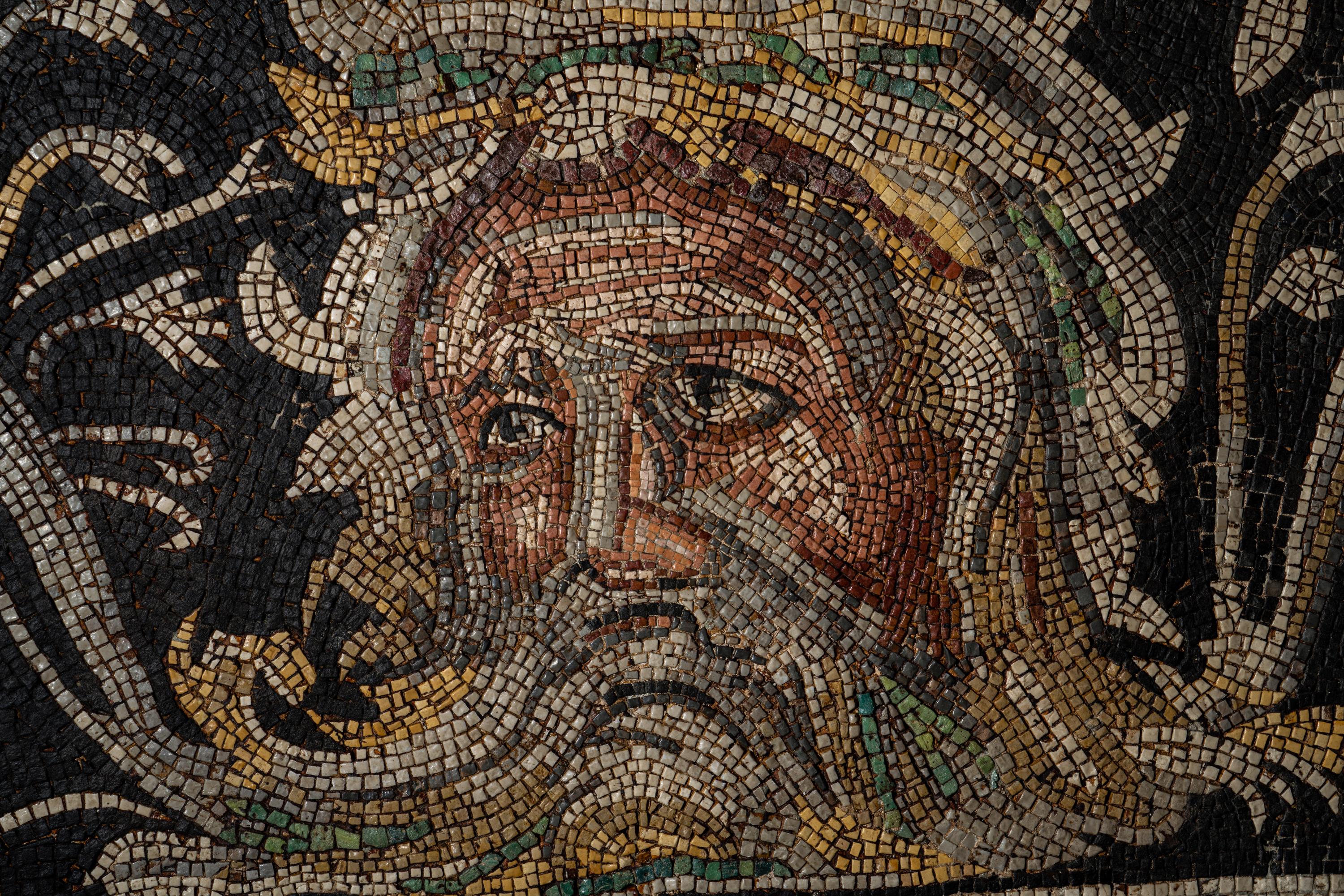 A Roman-Style Polychrome Mosaic Panel with a Bearded Head and Two Animals