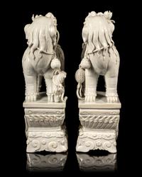 A Pair of Chinese Blanc-de-Chine Figures of Fu Lions