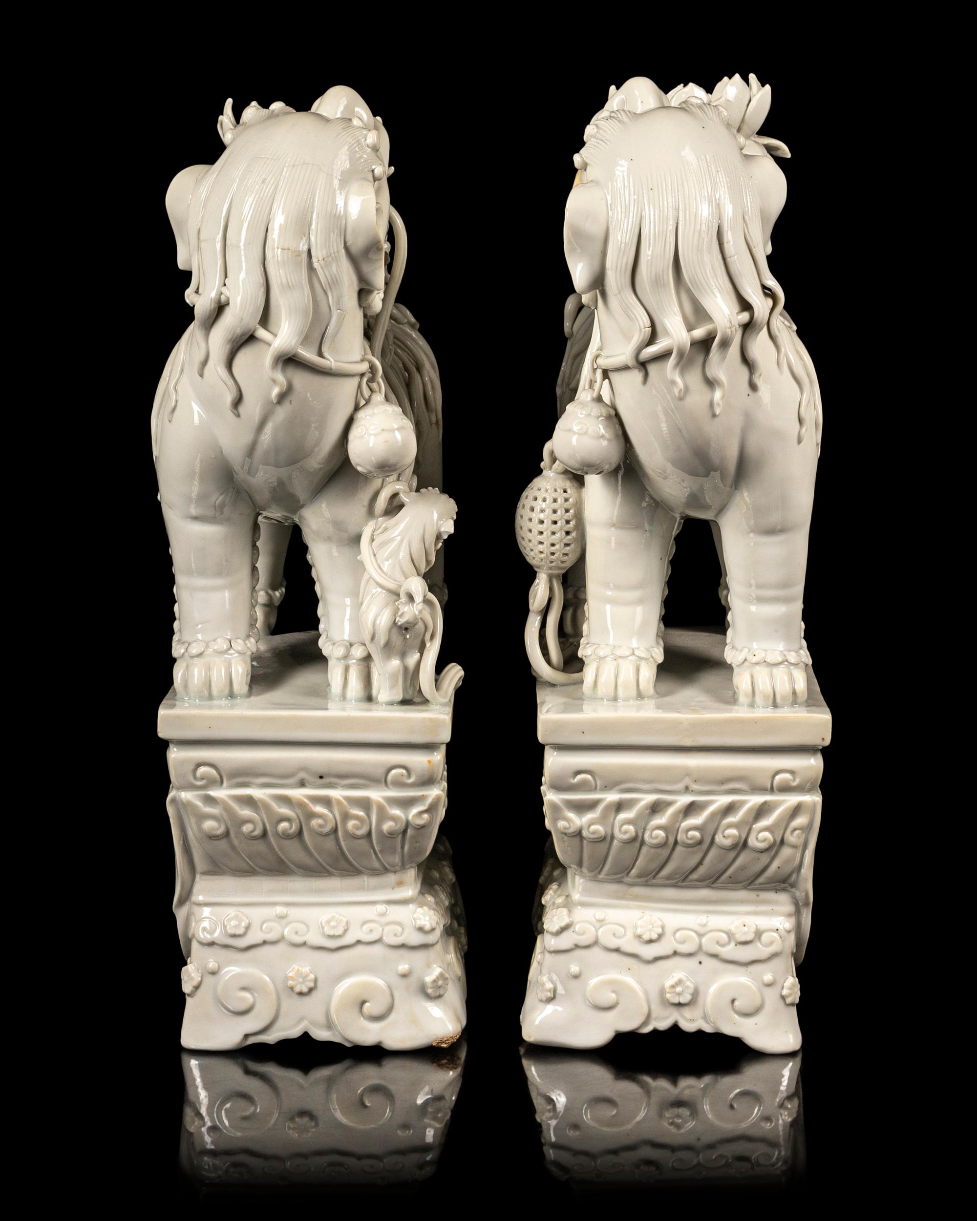 A Pair of Chinese Blanc-de-Chine Figures of Fu Lions