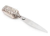 A Mexican Silver Paper Knife, Margot van Voorhies Carr, Taxco, Mid-20th Century, the handle worked with an Aztec deity, the reverse ins