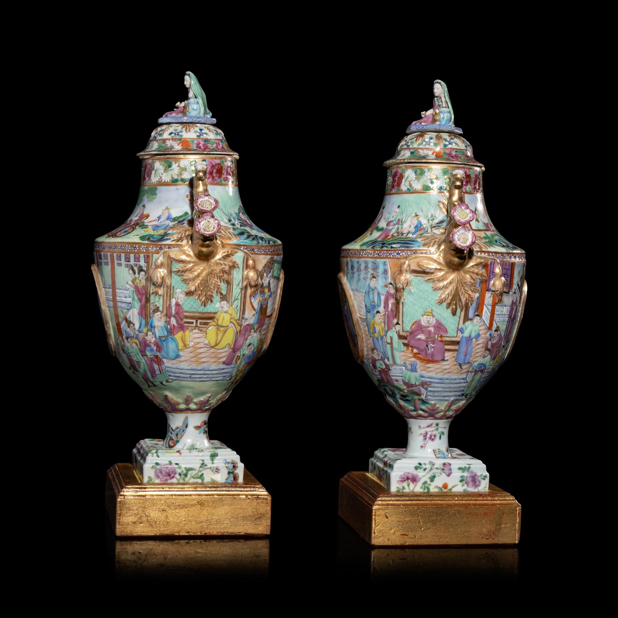A Pair of Chinese Export Canton Famille Rose Porcelain Covered Urns, Early 19th Century — 清晚期 外銷廣彩人物故事圖獎杯形賞瓶一對