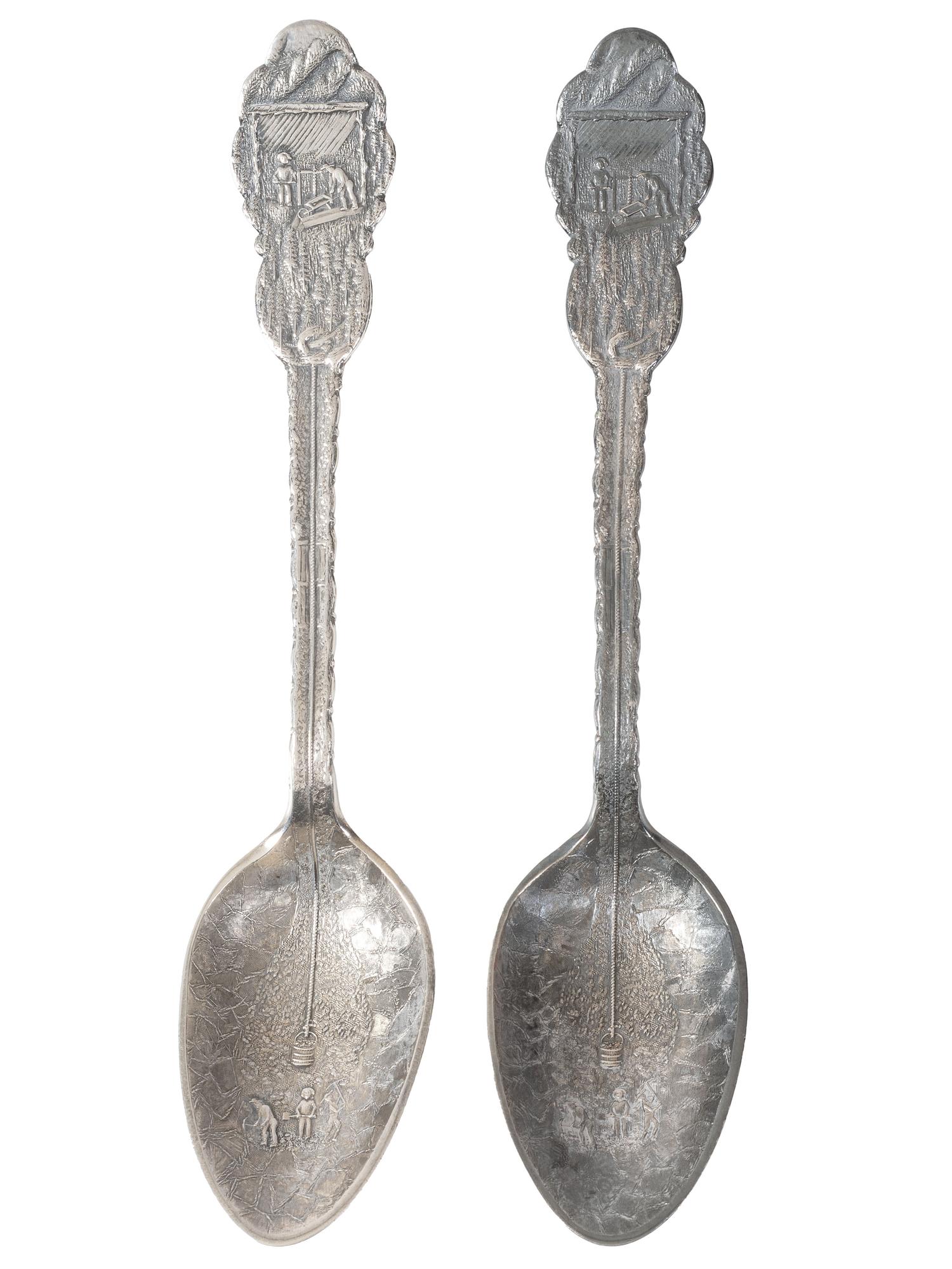 [WESTERN AMERICANA]. A group of 2 Henry Bohm silver banquet spoons commissioned by railroad magnate Otto Mears and featuring detailed mining scenes, ca 1890s.