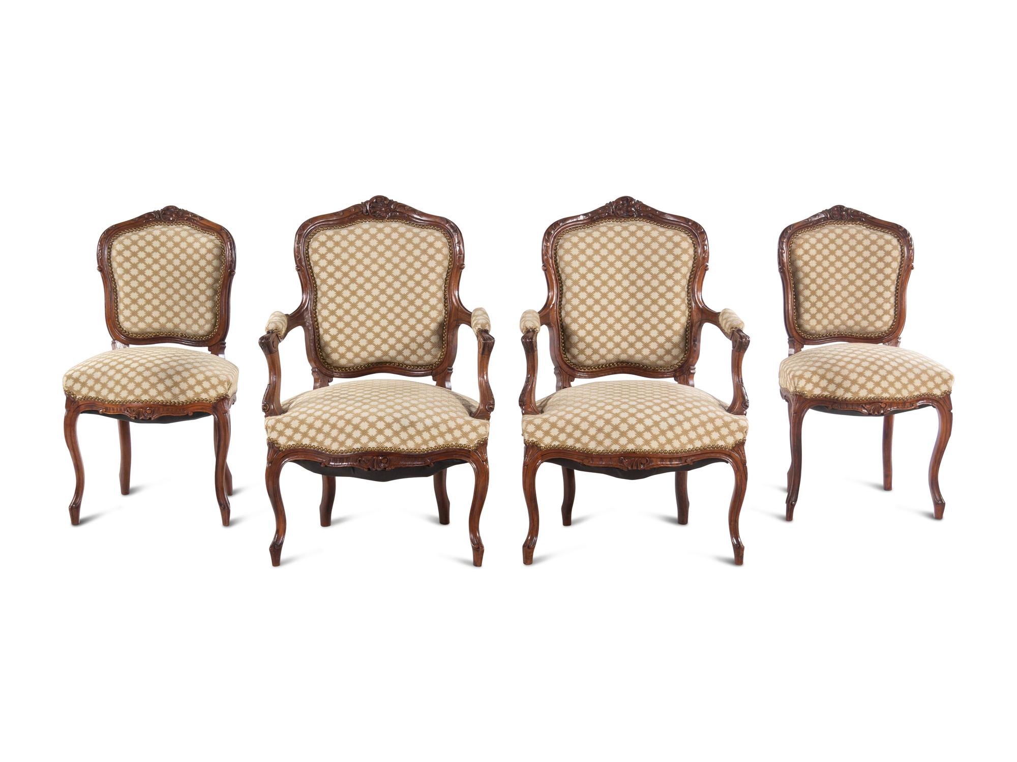 A Set of Four Louis XV Style Carved Walnut Chairs