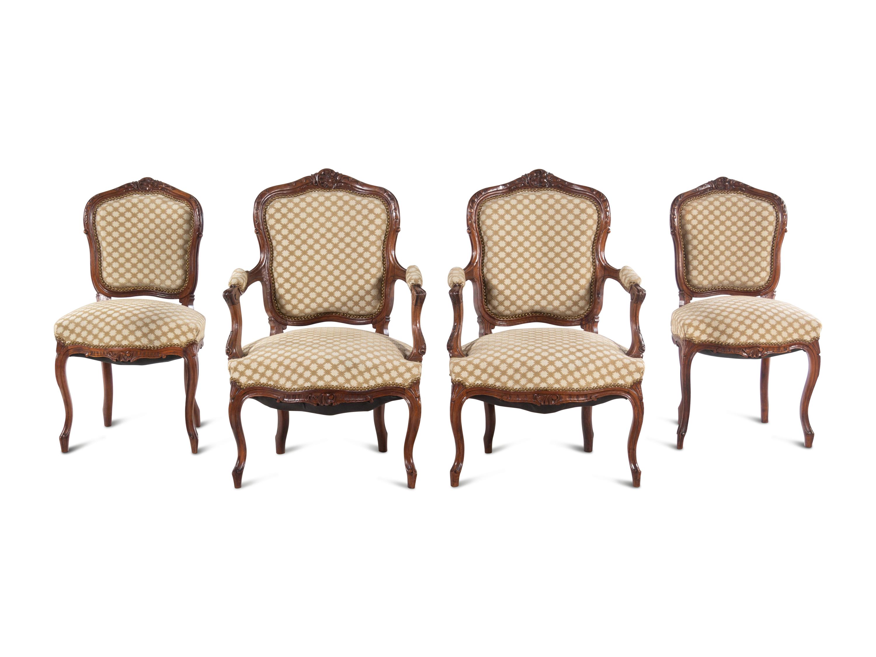 A Set of Four Louis XV Style Carved Walnut Chairs