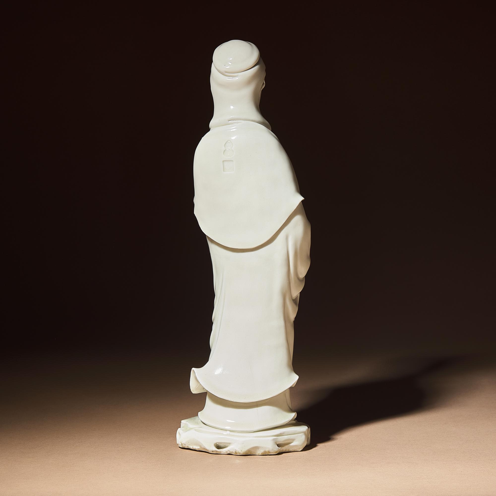 A Chinese Blanc-de-Chine Porcelain Standing Figure of Guanyin with 'He Chaozong' Mark, Qing Dynasty — 清 何朝宗款德化白瓷觀音立像