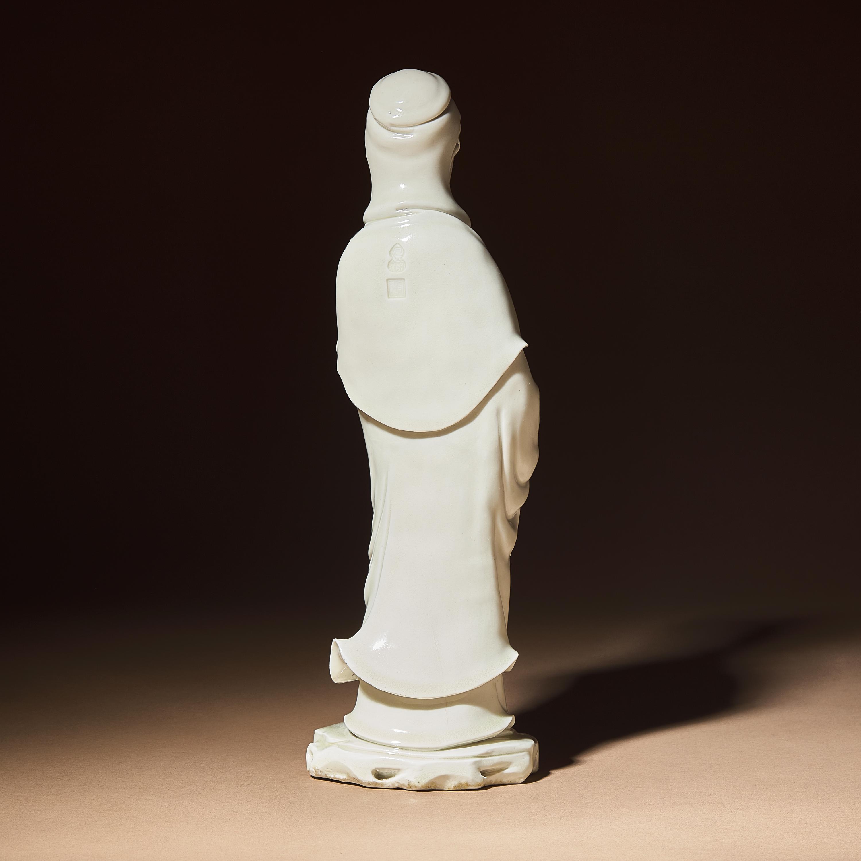 A Chinese Blanc-de-Chine Porcelain Standing Figure of Guanyin with 'He Chaozong' Mark, Qing Dynasty — 清 何朝宗款德化白瓷觀音立像