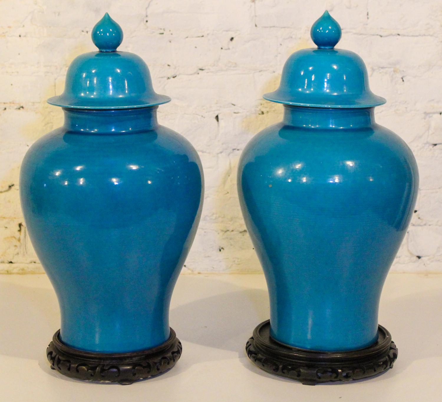 A Pair of Chinese Turquoise Glazed Porcelain Baluster Vases and Covers. Height 20 inches.