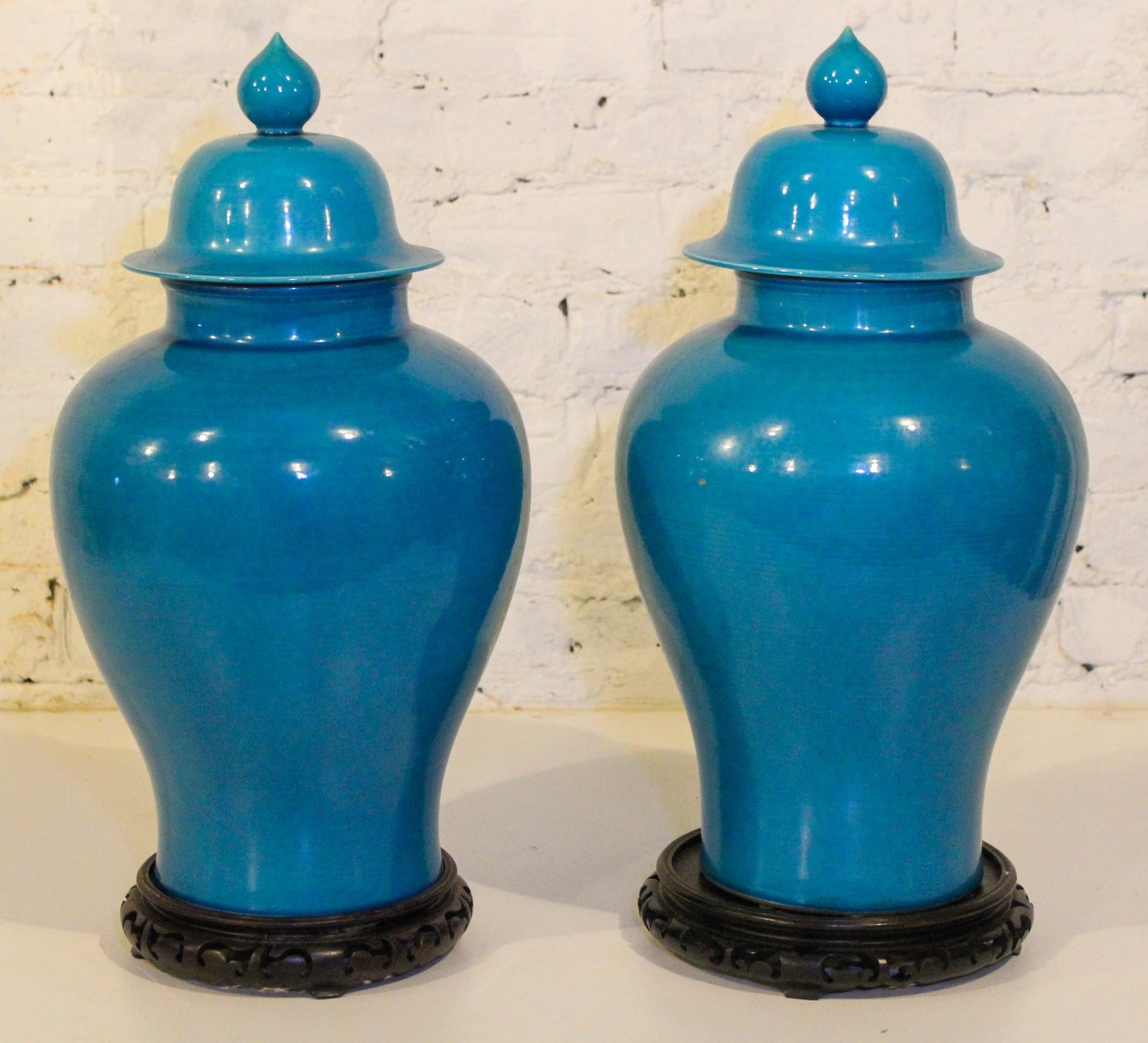 A Pair of Chinese Turquoise Glazed Porcelain Baluster Vases and Covers. Height 20 inches.