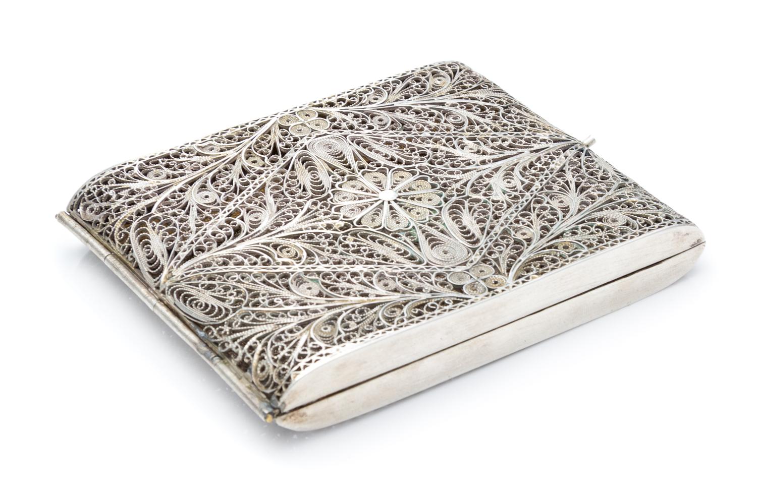 A Silver Filigree Cigarette Case, , the case centered with a flowerhead among foliate scrolls.