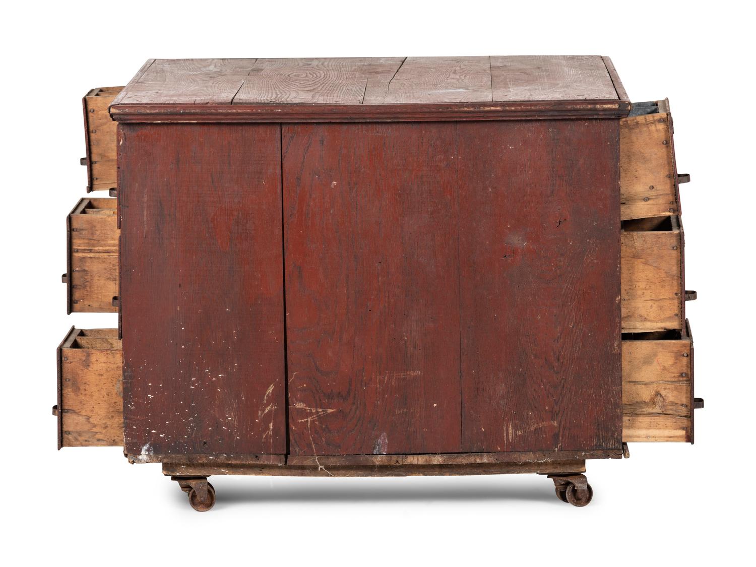 A Red Painted Pine Storage Chest on Casters