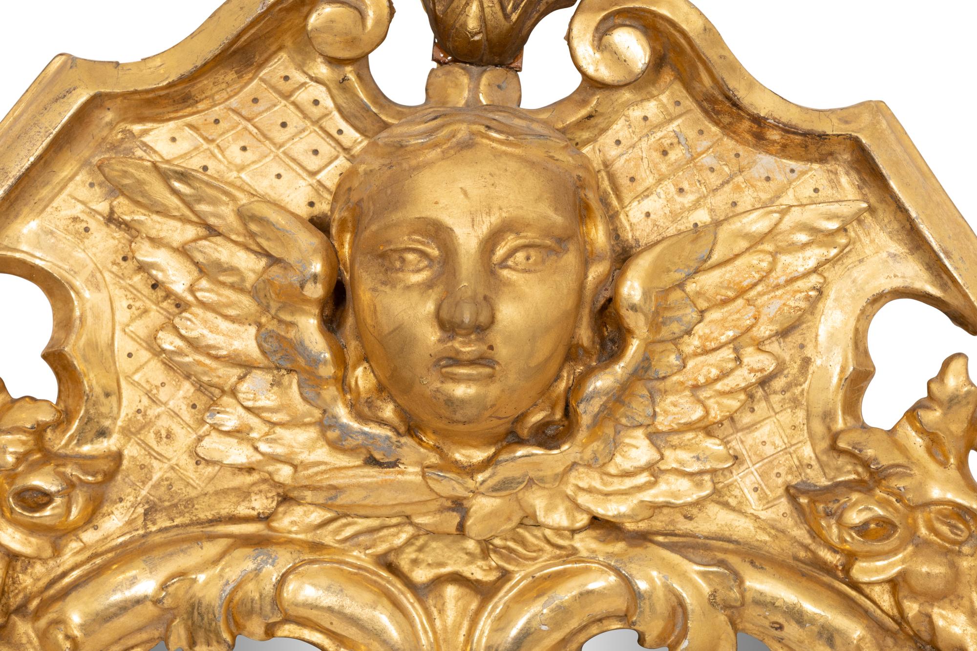 A Continental Baroque Cartouche-Form Giltwood Mirror