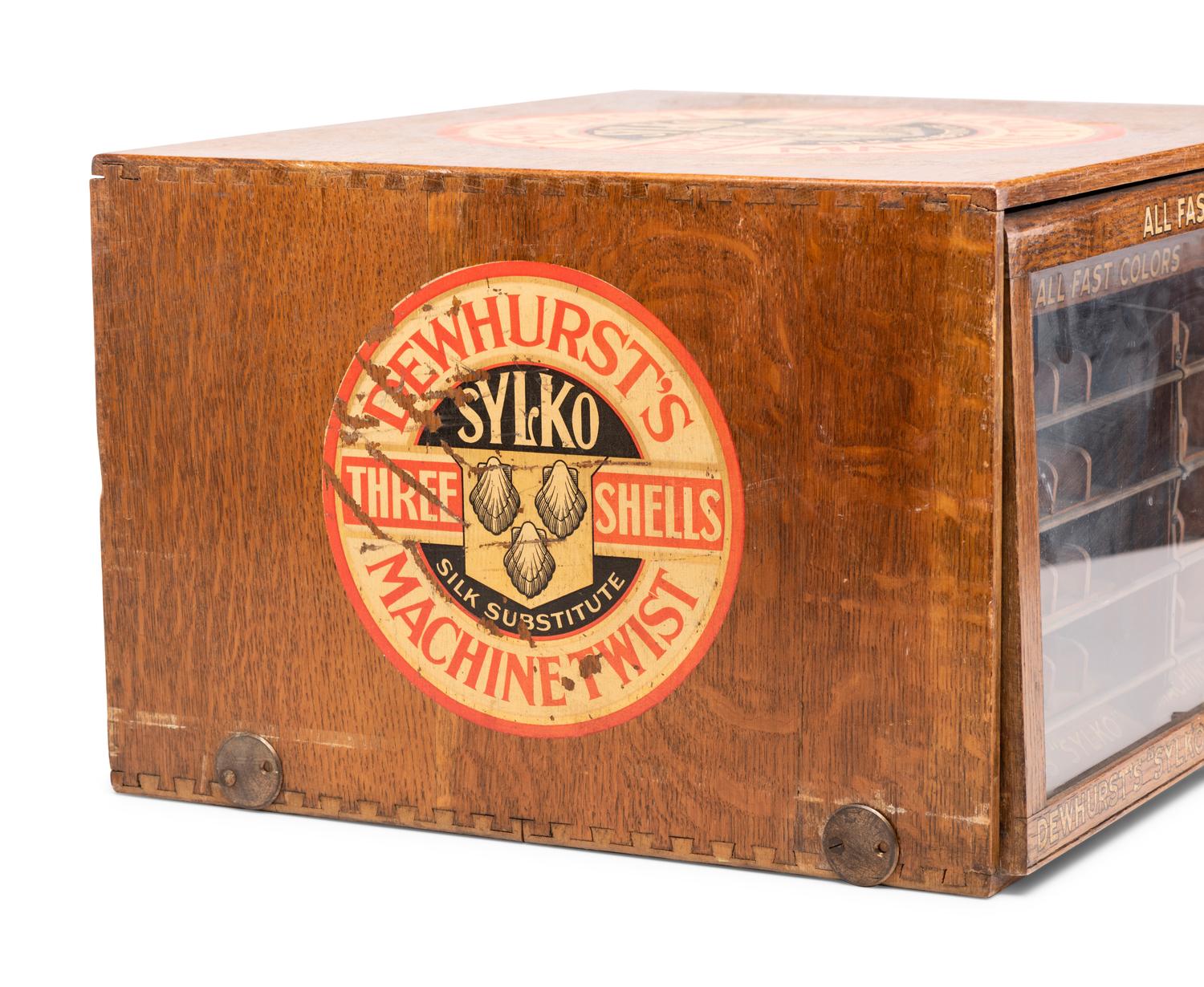 A Dewhurst's "Sylko" Stenciled Oak Spool Cabinet
