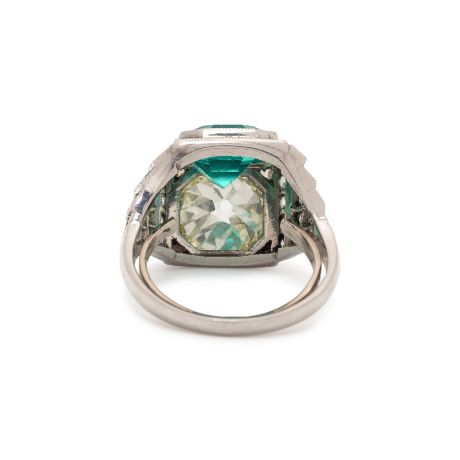 ART DECO, EMERALD AND DIAMOND SCULPTURAL 'TOI ET MOI' RING