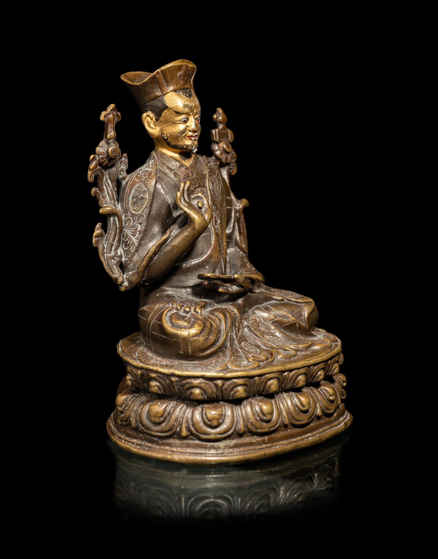 A Tibetan Parcel Gilt Bronze Figure of a Seated Lama