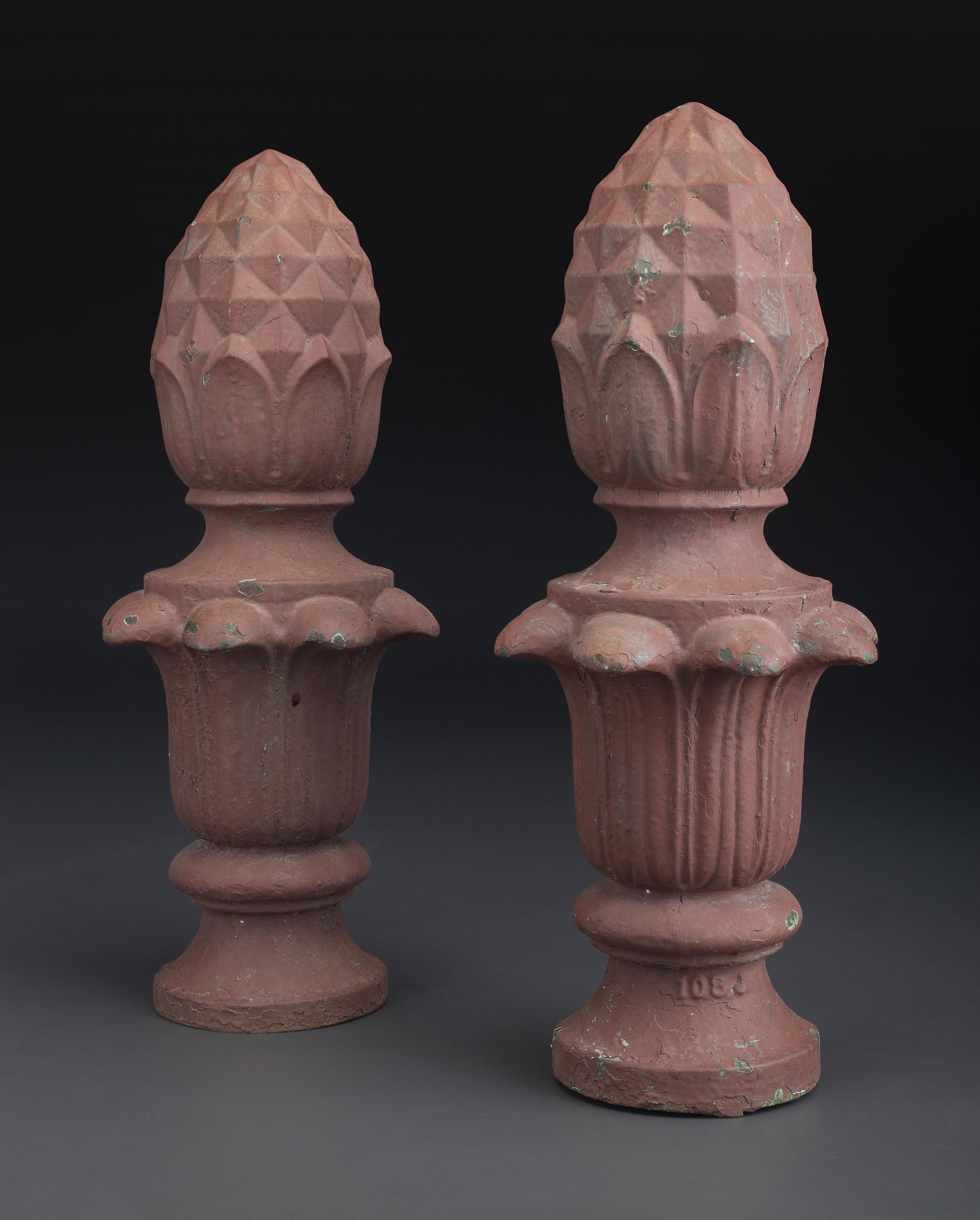 A Pair of Red Painted Cast Iron Architectural Finials