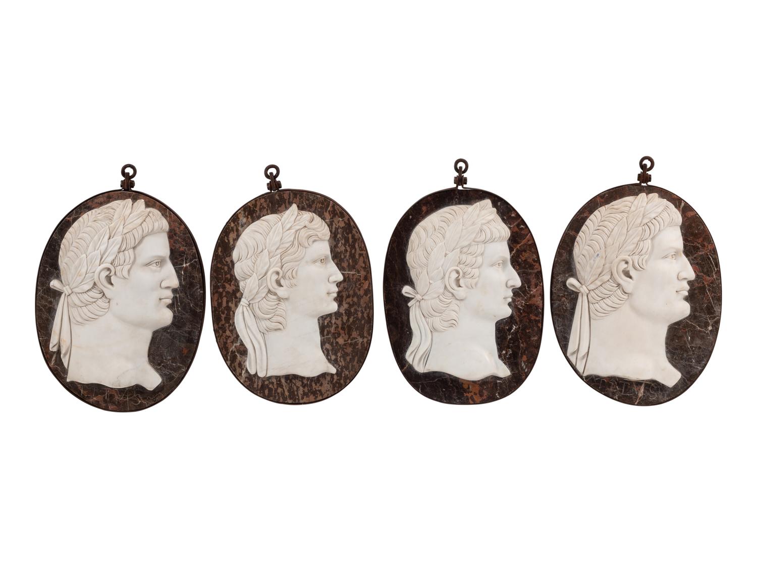 A Set of Four Italian Neoclassical Style Iron Mounted Marble Portrait Medallions