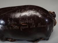 An Anna Pottery Incised and Brown Glazed Pig Flask
