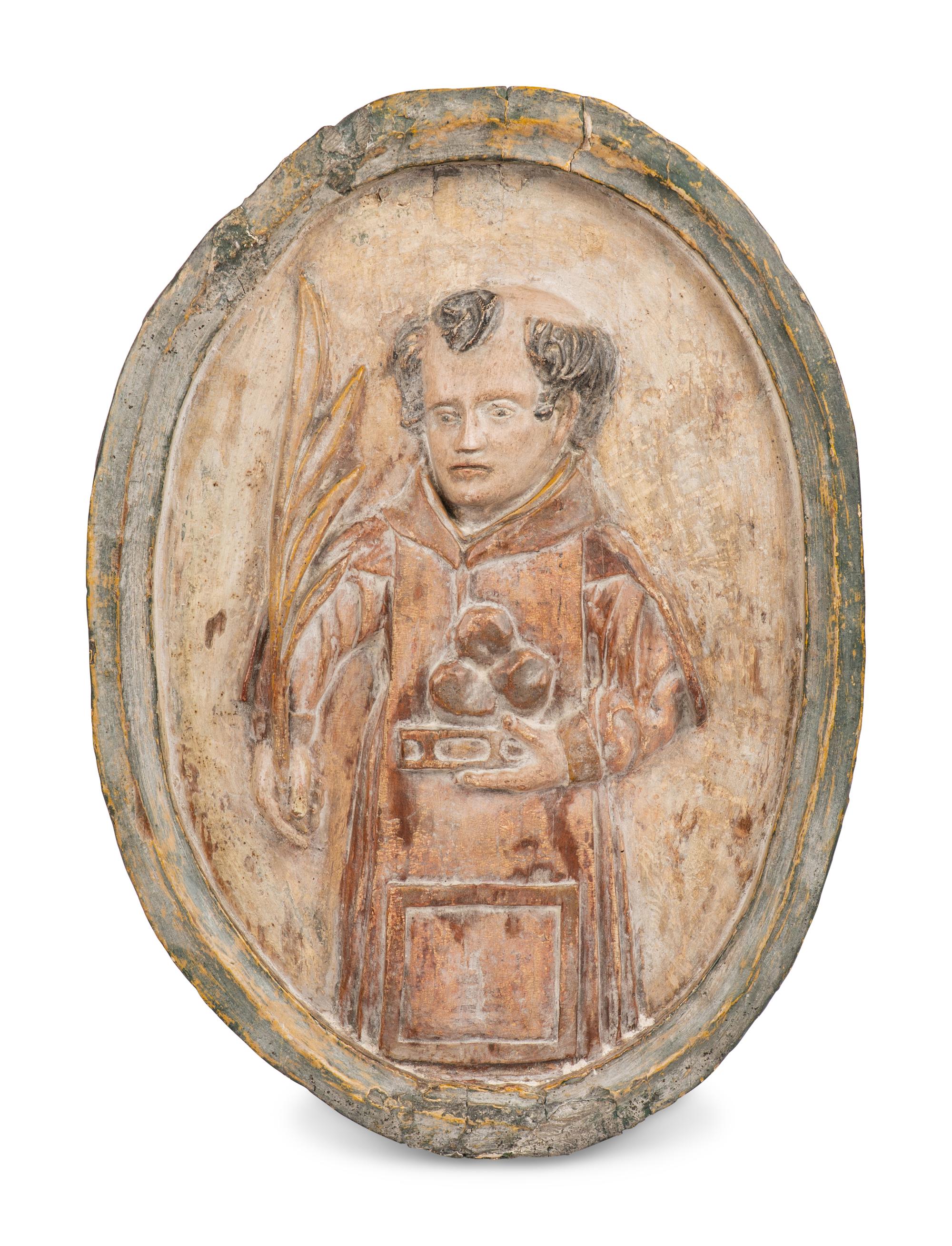 A Continental Carved Wood Plaque Depicting Saint Anthony of Padua