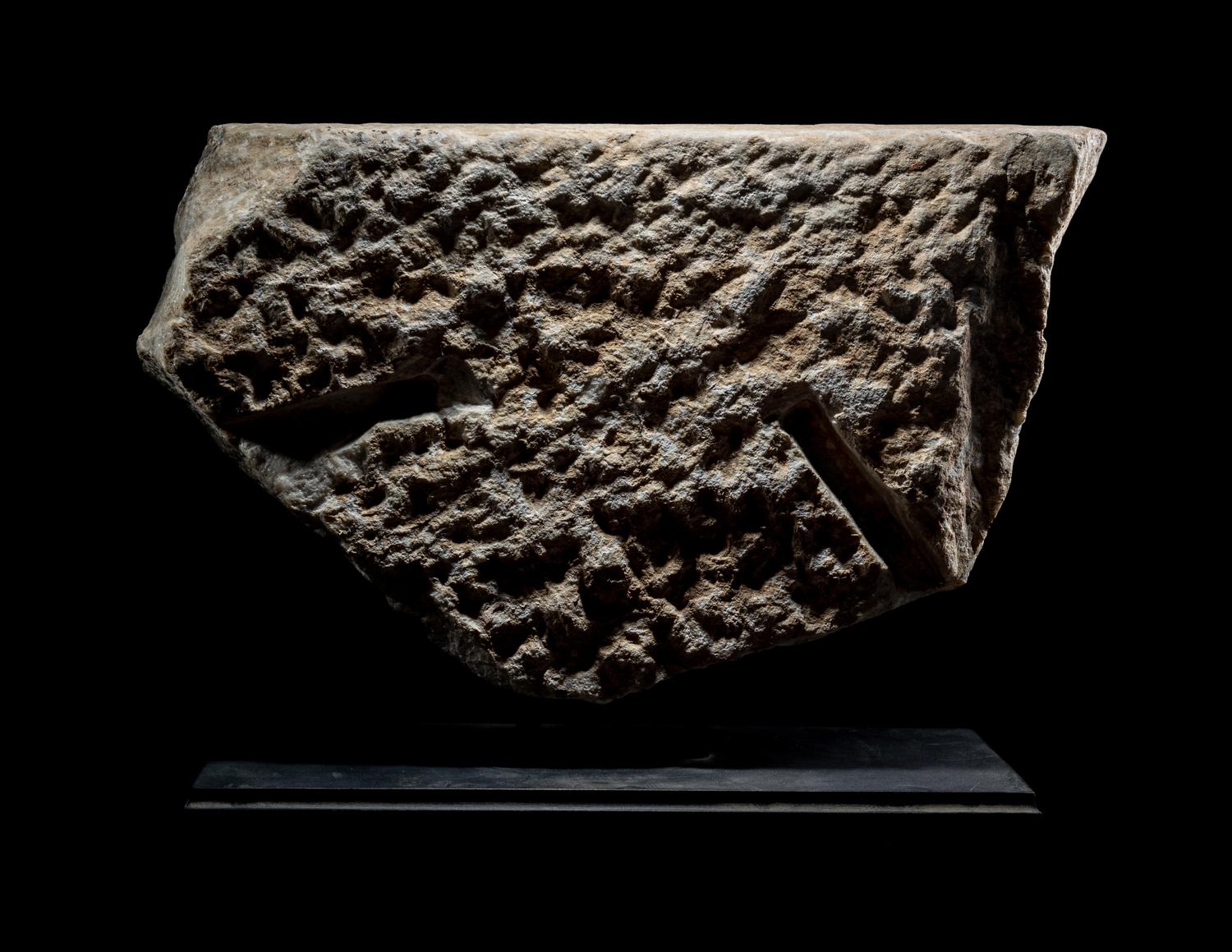 A Roman Marble Sarcophagus Fragment with Eros Holding Snakes