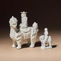 Two Chinese Blanc-de-Chine Porcelain Figural Groups of Foreigners Riding on Qilin, Late 17th-Early 18th Century — 清中期 德化白瓷骑麒麟西人像兩件