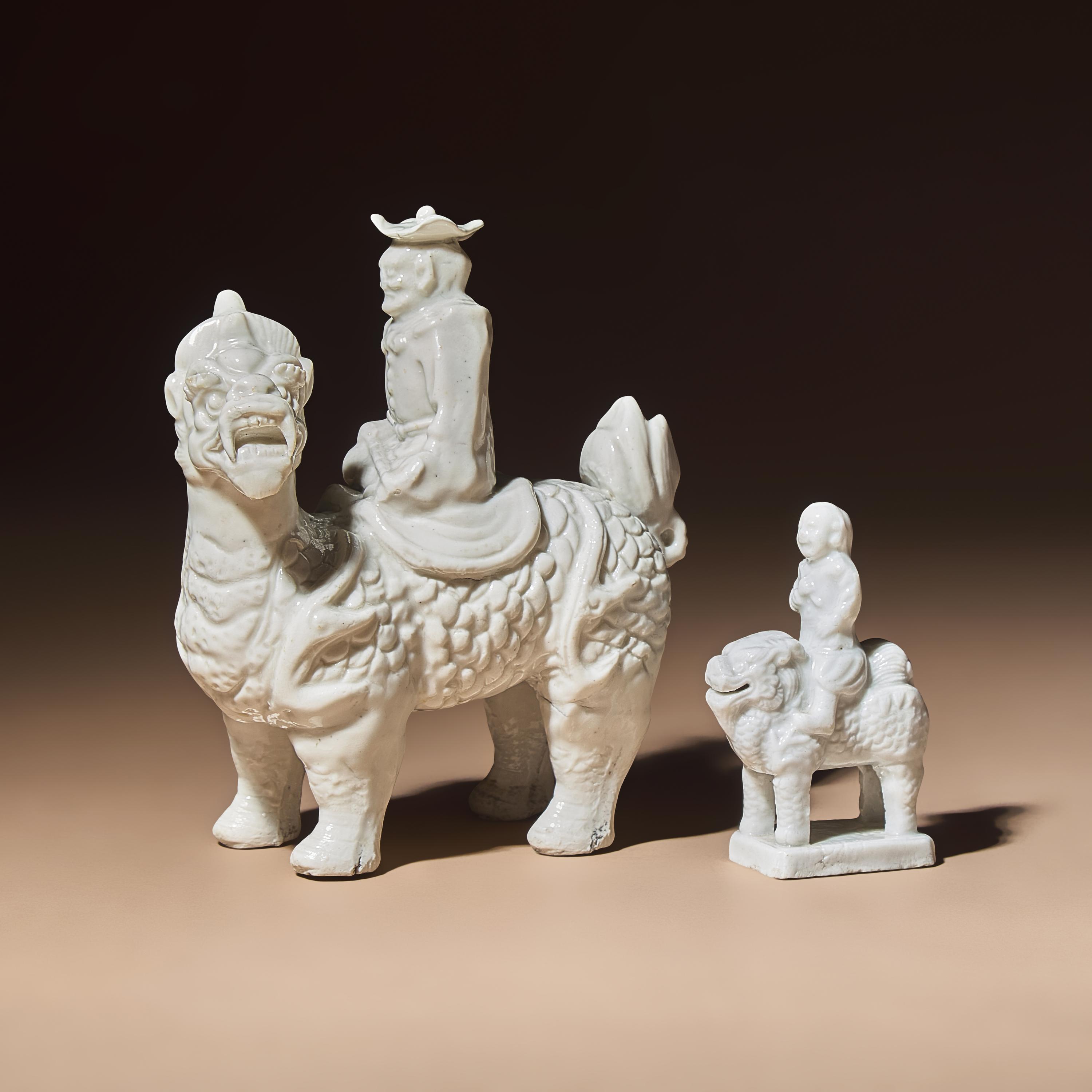 Two Chinese Blanc-de-Chine Porcelain Figural Groups of Foreigners Riding on Qilin, Late 17th-Early 18th Century — 清中期 德化白瓷骑麒麟西人像兩件