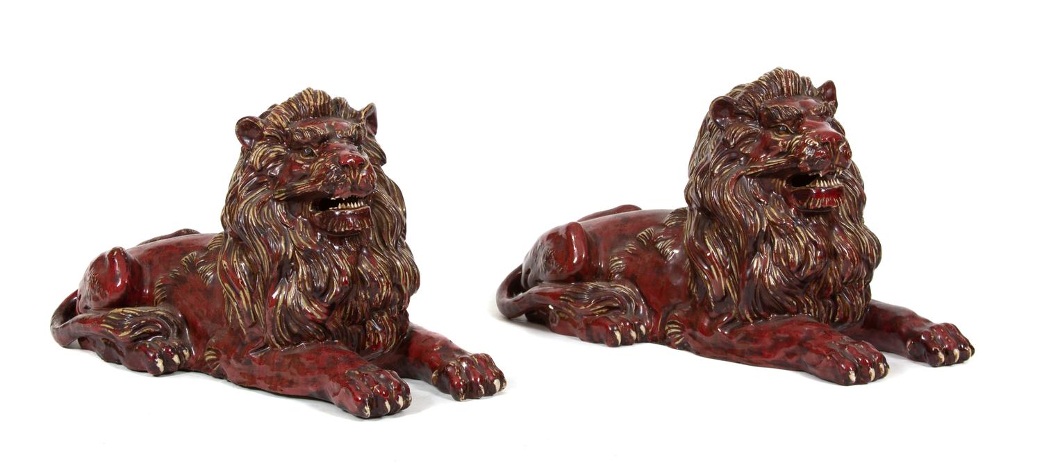 A Pair of Italian Glazed Recumbent Lions Length 30 inches. — 20TH CENTURY