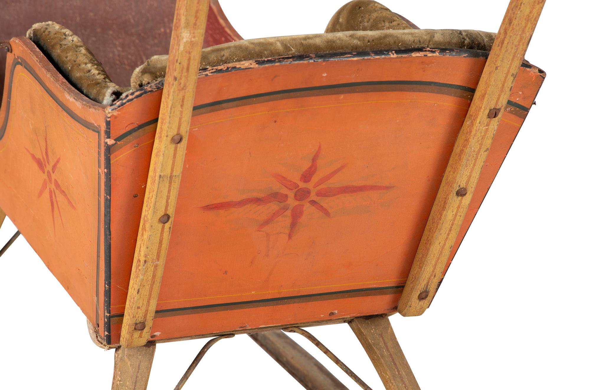 A Paint Decorated and Velvet Upholstered Wood Child's Sleigh