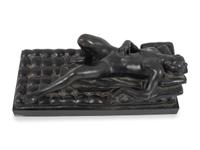 A Cast Bronze Figure of a Reclining Nude Woman