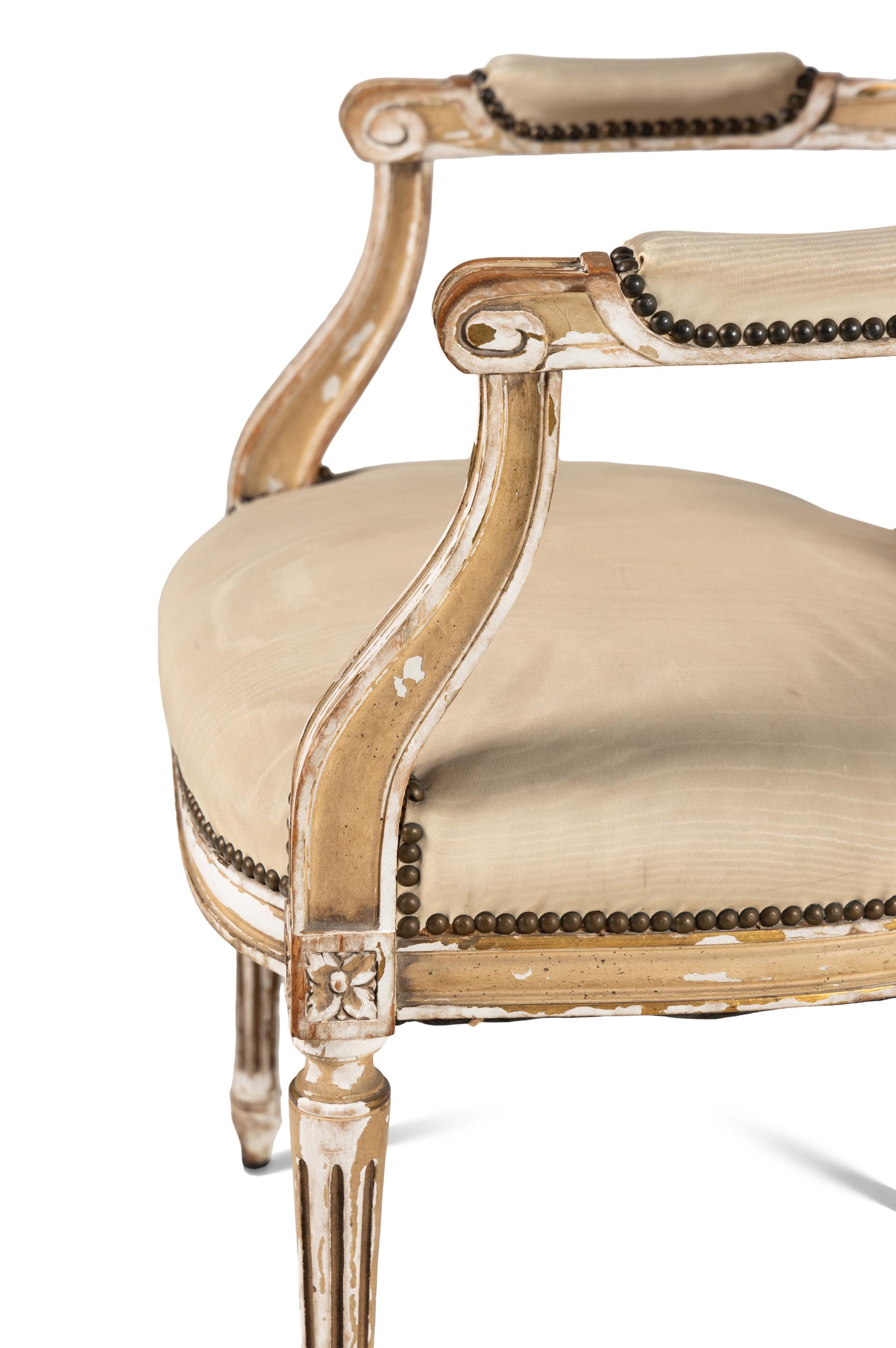 A Pair of Louis XVI Style Painted and Parcel Gilt Fauteuils