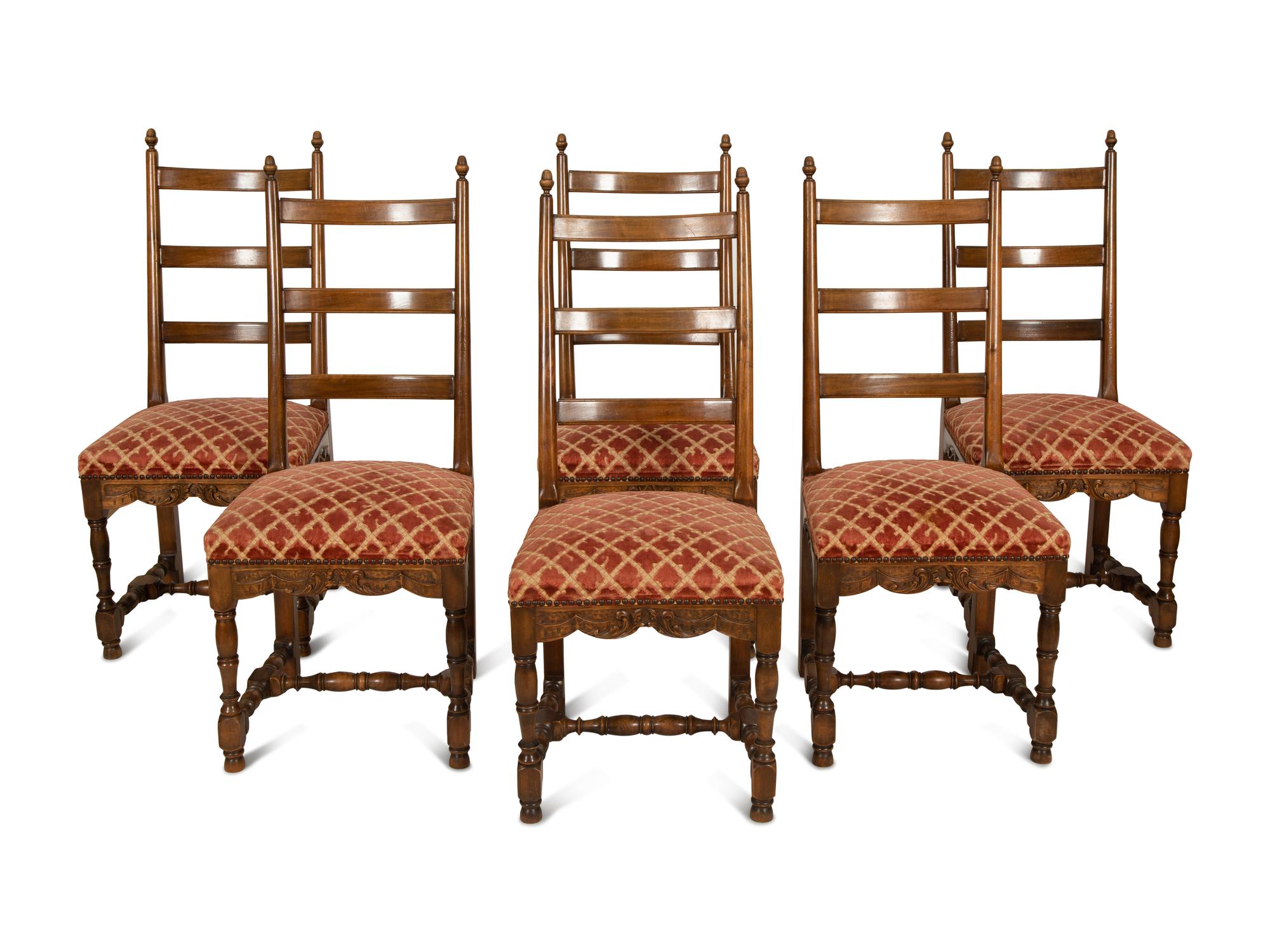 A Set of Six French Provincial Carved Walnut Dining Chairs